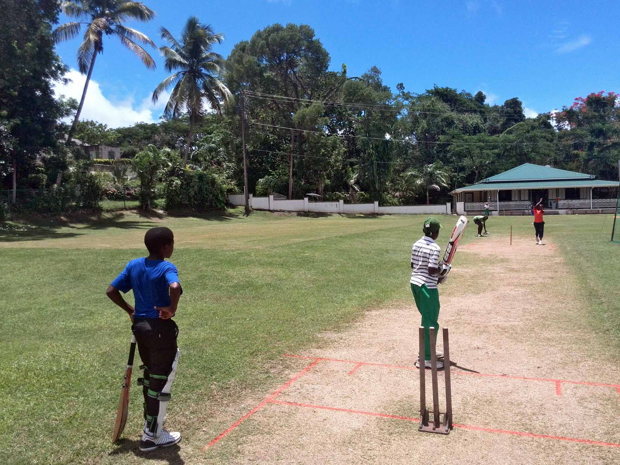 On the ball: local boys playing cricket