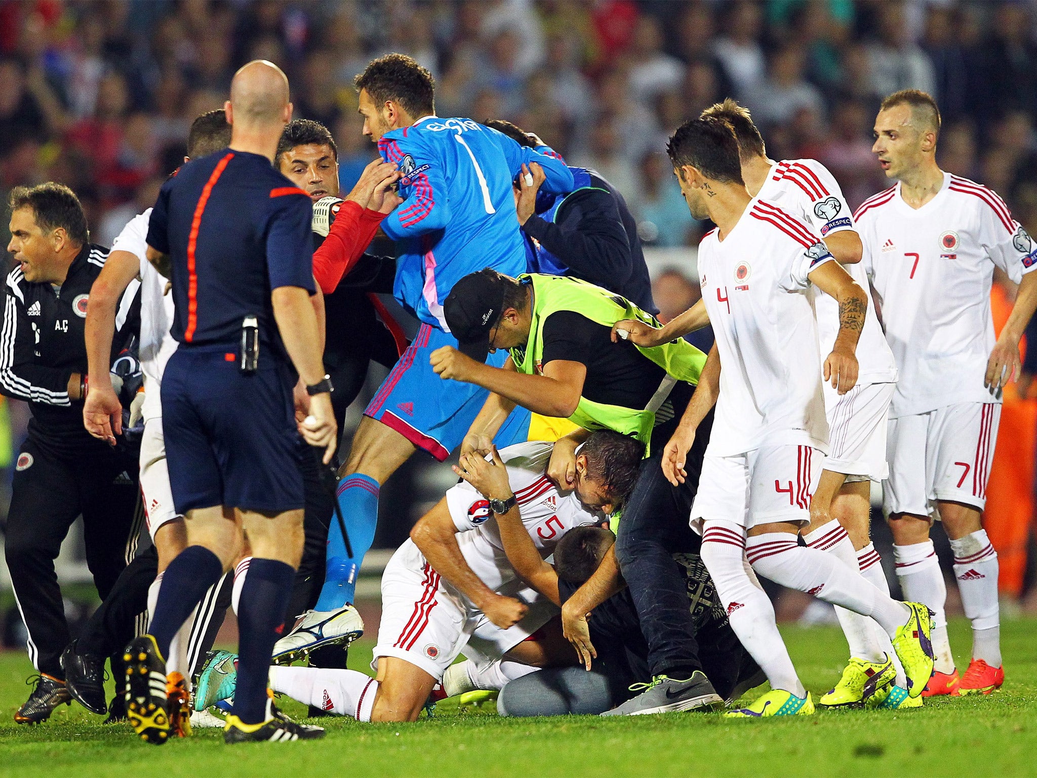 A brawl between players and supporters on the pitch