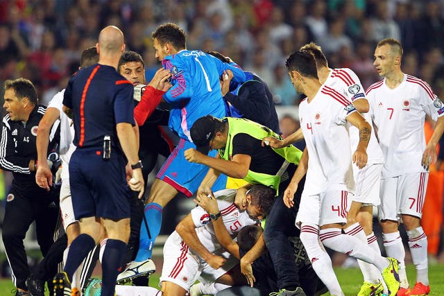A brawl between players and supporters on the pitch before the match