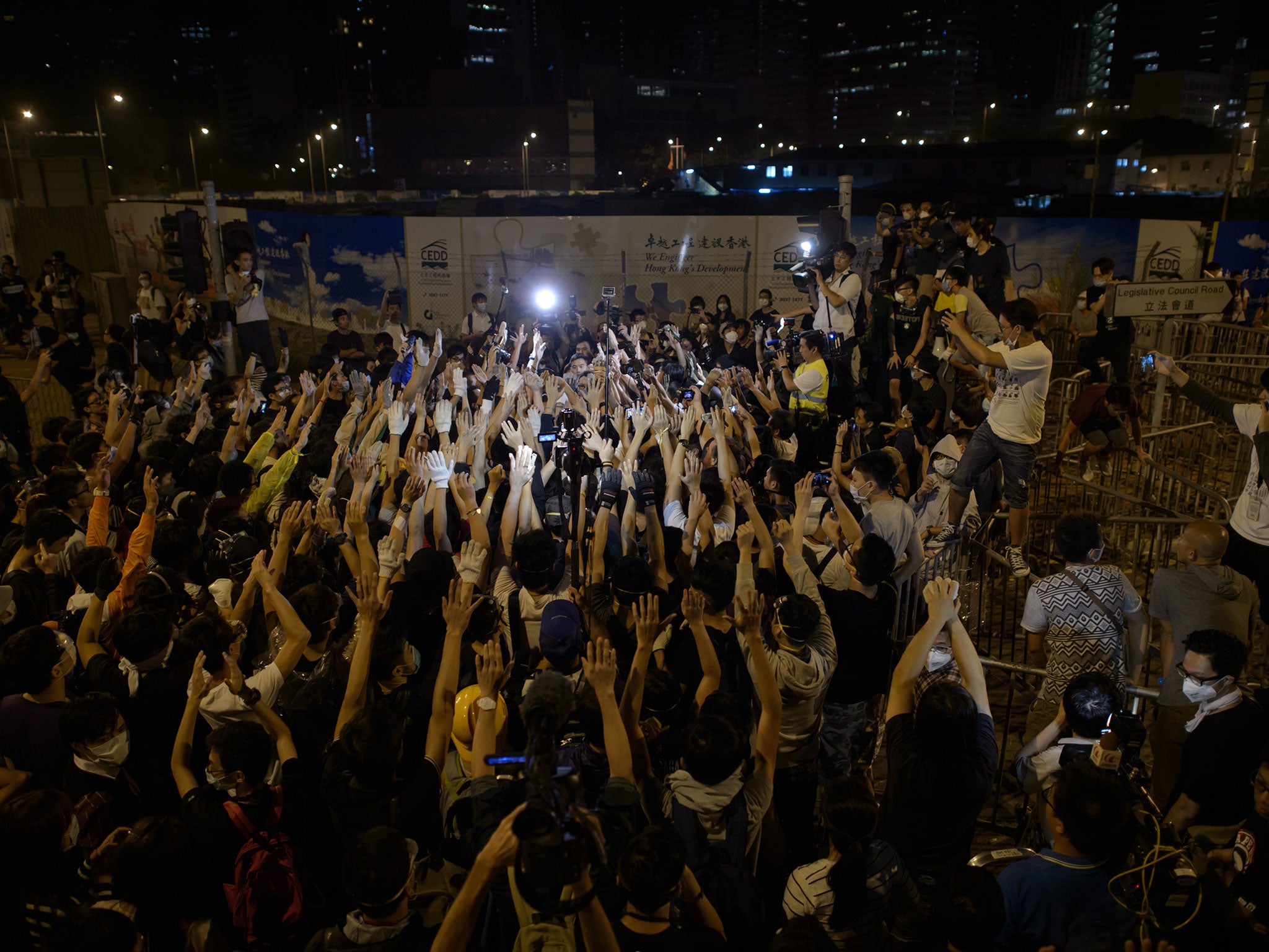 CPro-democracy protesters confront a group of policemen outside the central government offices in the Admiralty district of Hong Kong on October 15, 2014.