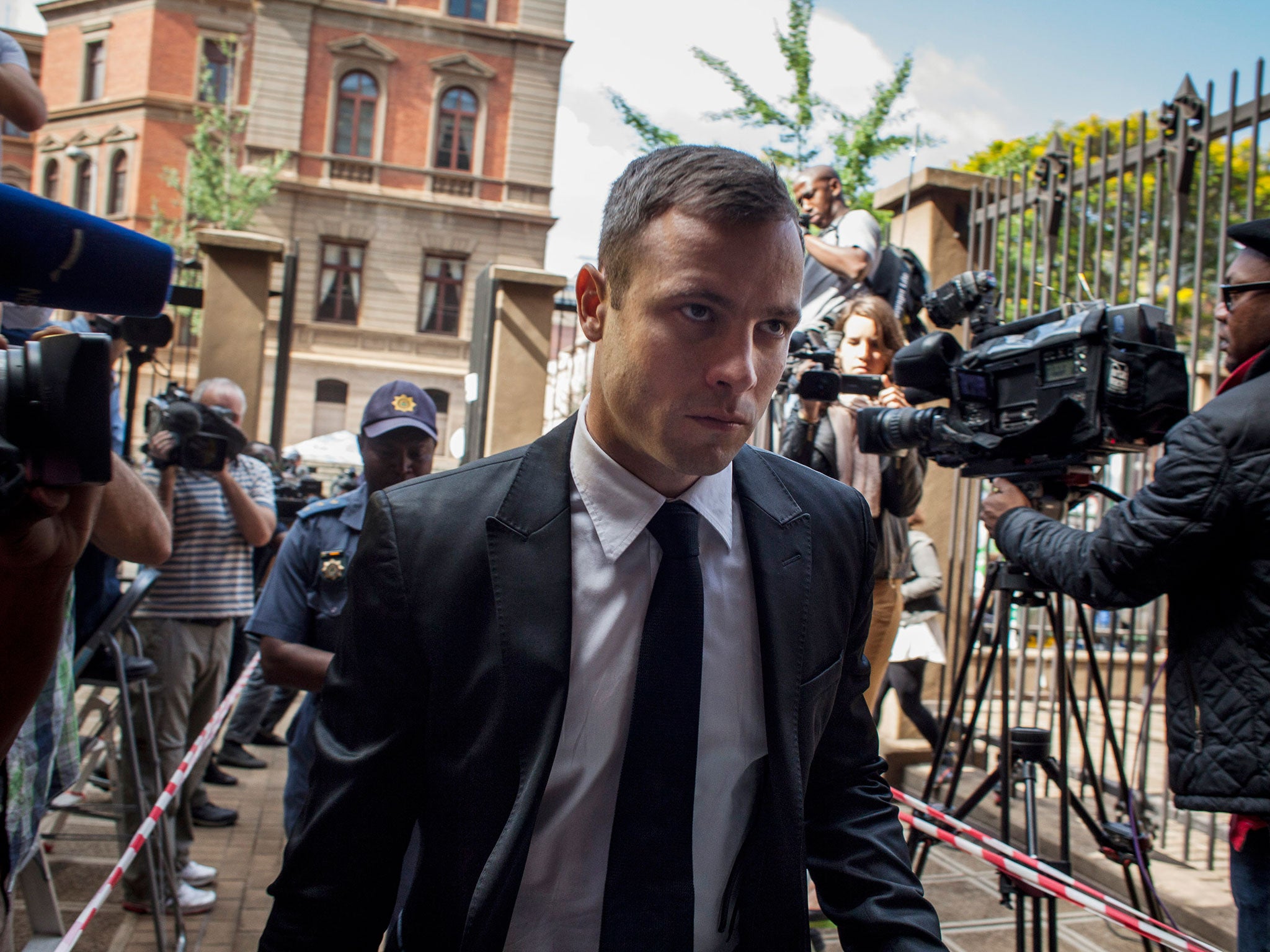 Oscar Pistorius arrives for the fourth day of sentencing at North Gauteng High Court on October 16, 2014 in Pretoria, South Africa.
