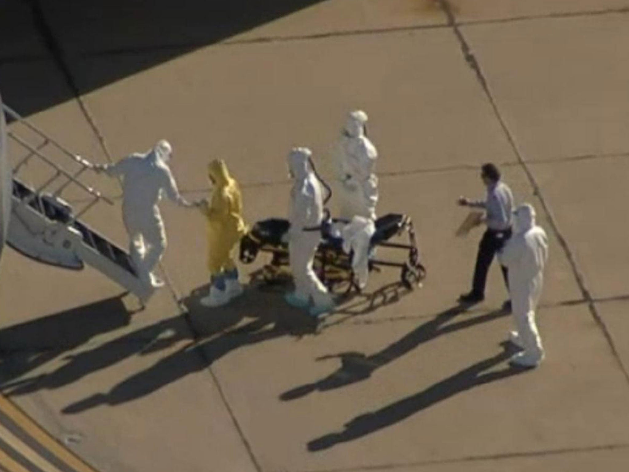 Video footage has emerged of a plain-clothed man surrounded by people in full hazmat suits transporting the second US Ebola patient to Atlanta