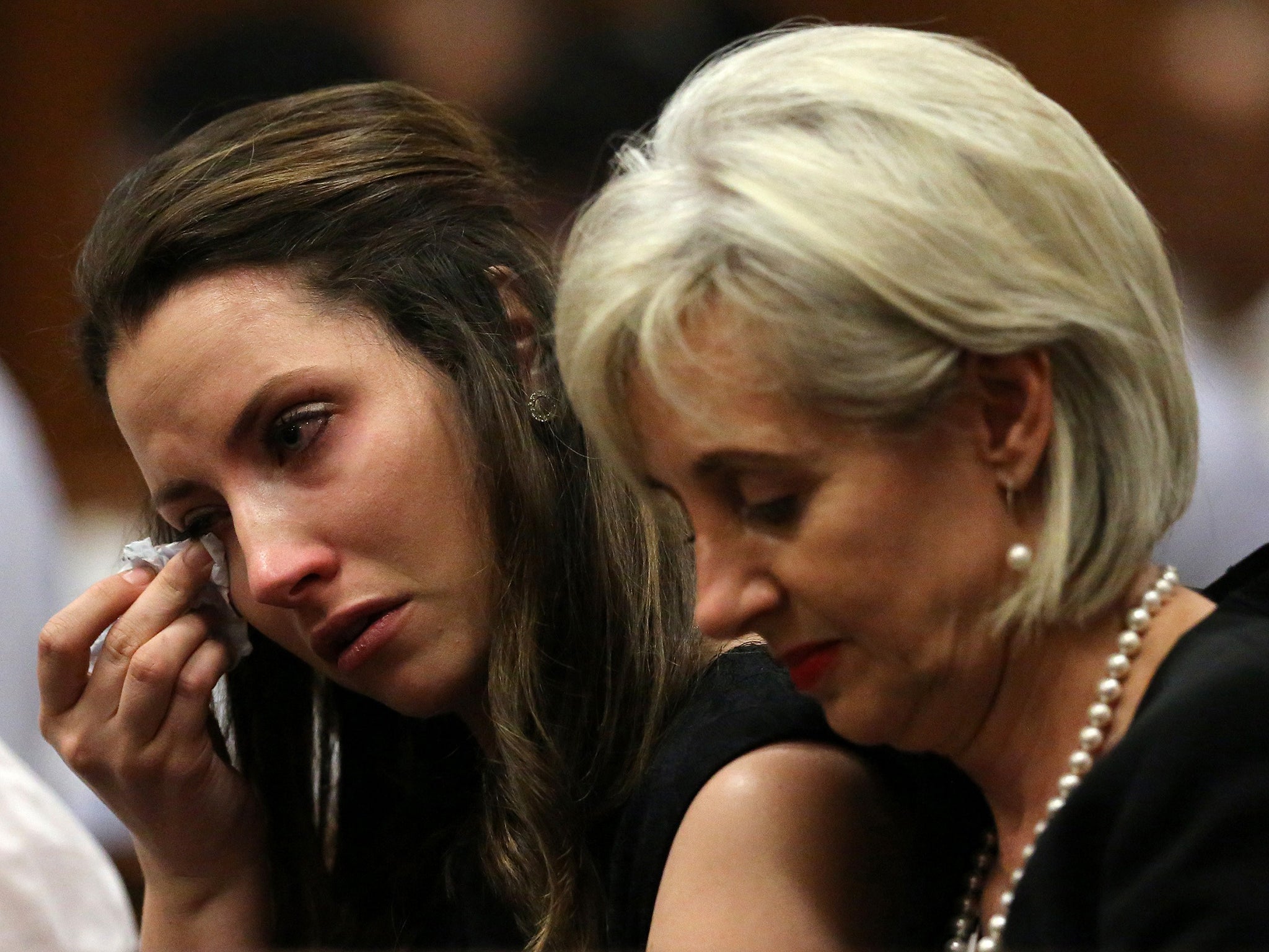 The sister of Oscar Pistorius, Aimee (L), sits next to her aunt Lois during his sentencing hearing at the North Gauteng High Court in Pretoria