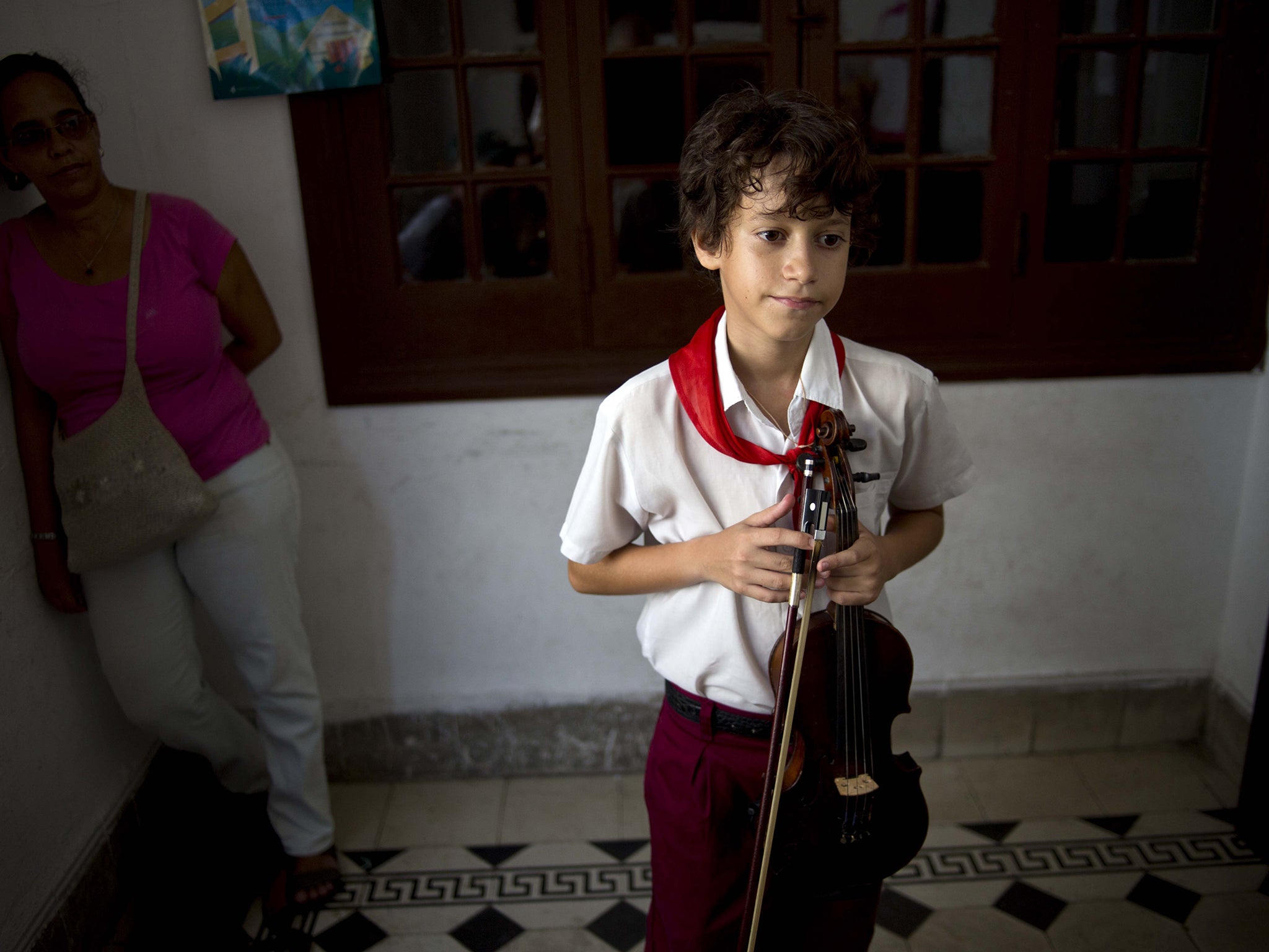 A young violinist takes a grades exam at a music school in the capital
AP