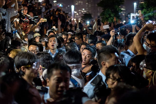 Police force their way through a crowd of pro-democracy
protesters in Hong Kong yesterday