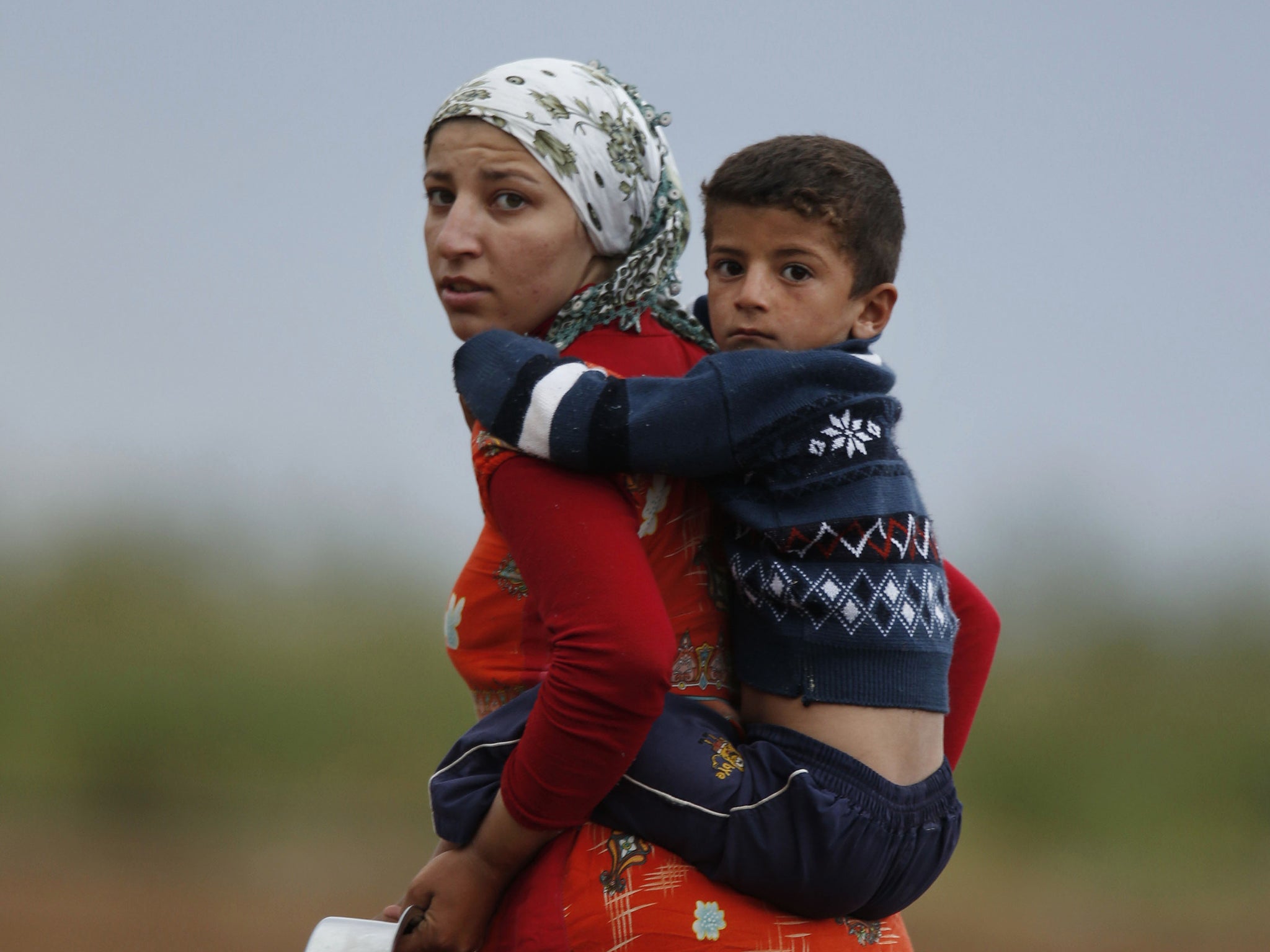 A Kurdish mother and son in the besieged town of Kobani