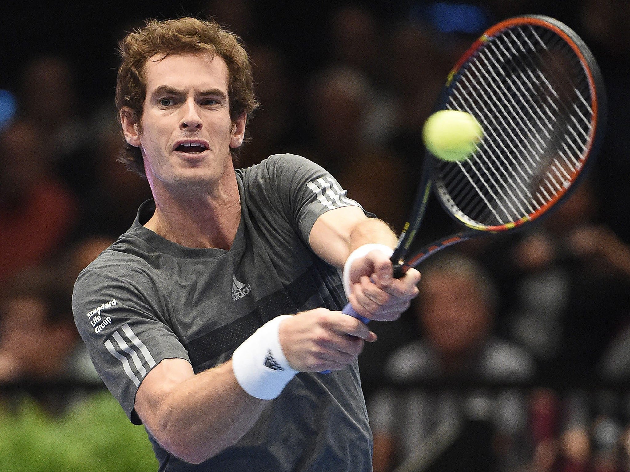 Andy Murray of Britain returns the ball to Vasek Pospisil of Canada