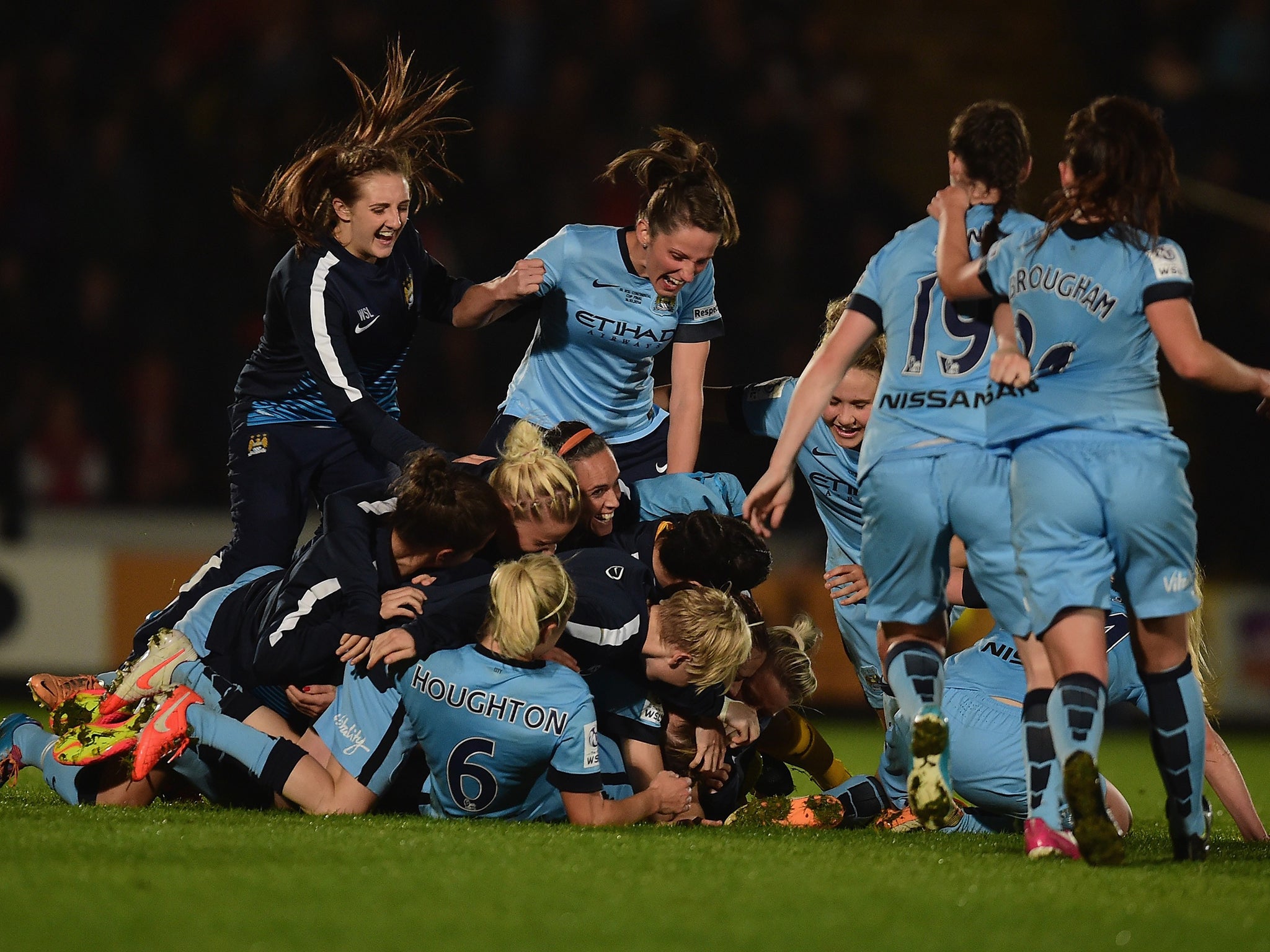 Manchester City’s jubilant players celebrate winning the
Continental Cup last night at Adams Park, High Wycombe