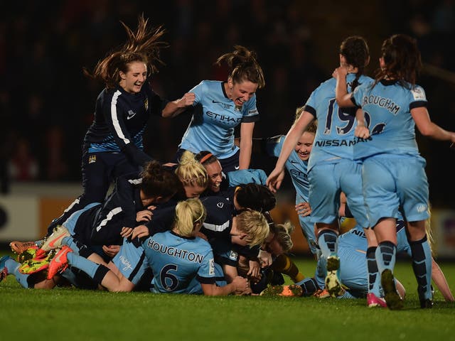 Manchester City’s jubilant players celebrate winning the
Continental Cup last night at Adams Park, High Wycombe