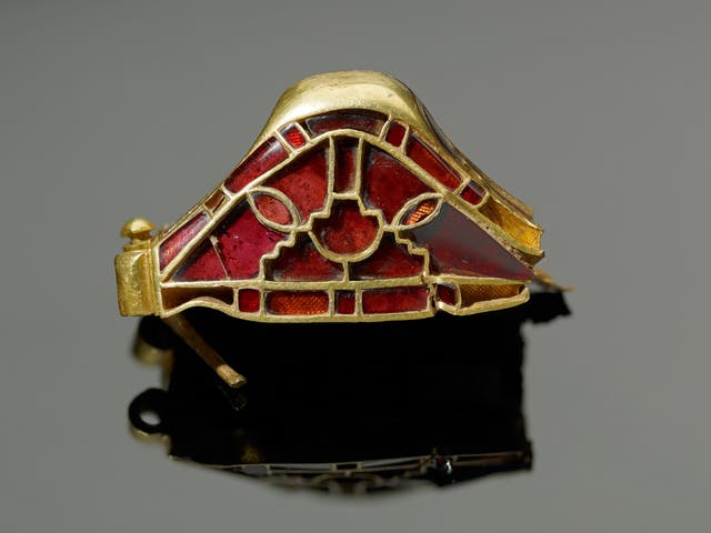 The garnets along the upper edge have been cut with a curved, instead of a flat, face, which would have been difficult to do.