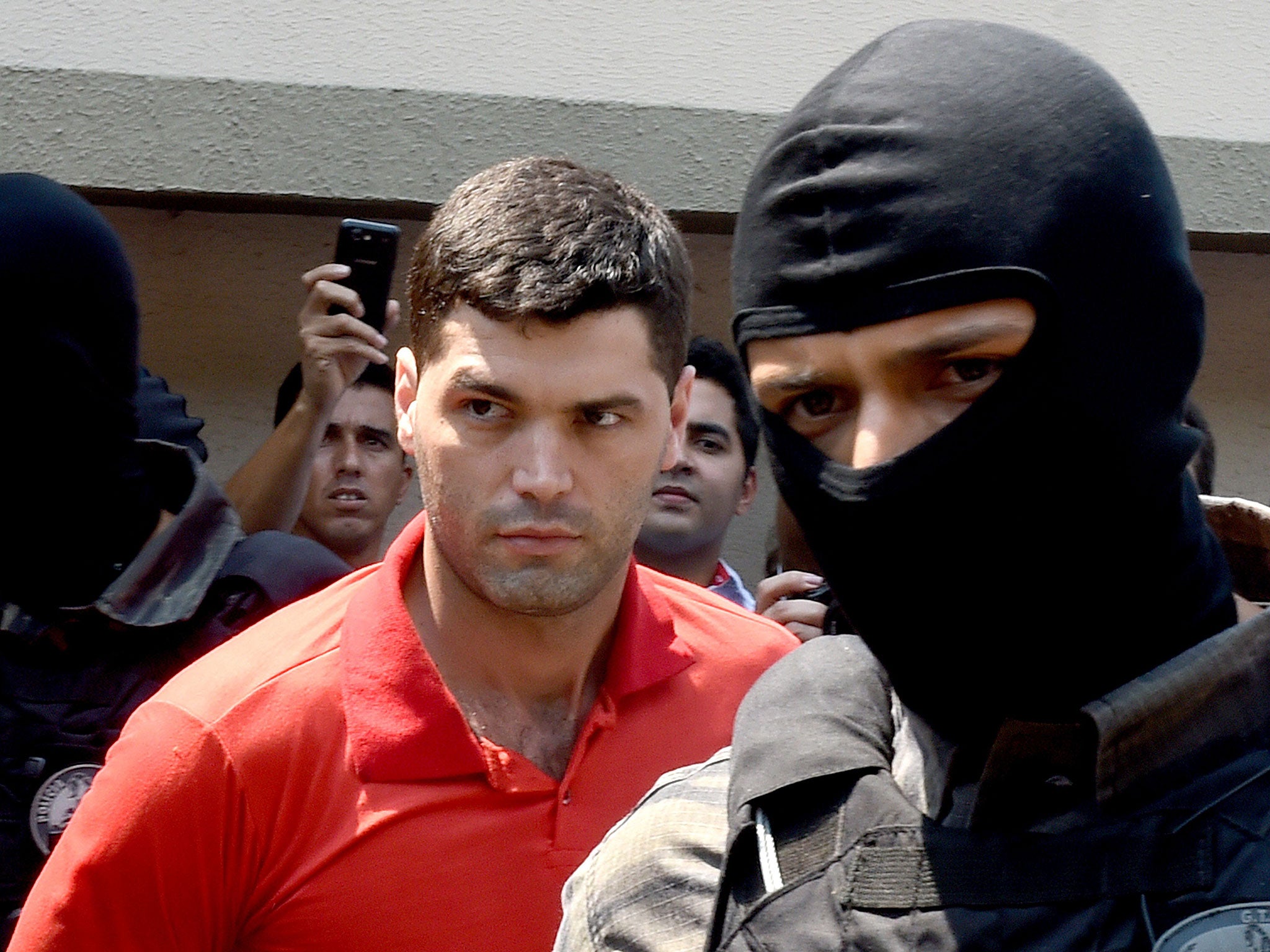 Thiago Henrique Gomes da Rocha is escorted by police after his arrest