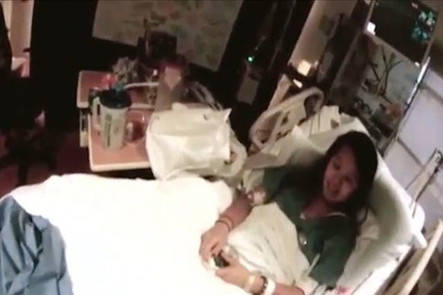 Nurse Nina Pham lies on her hospital bed at the Texas Health Presbyterian Hospital in Dallas, Texas