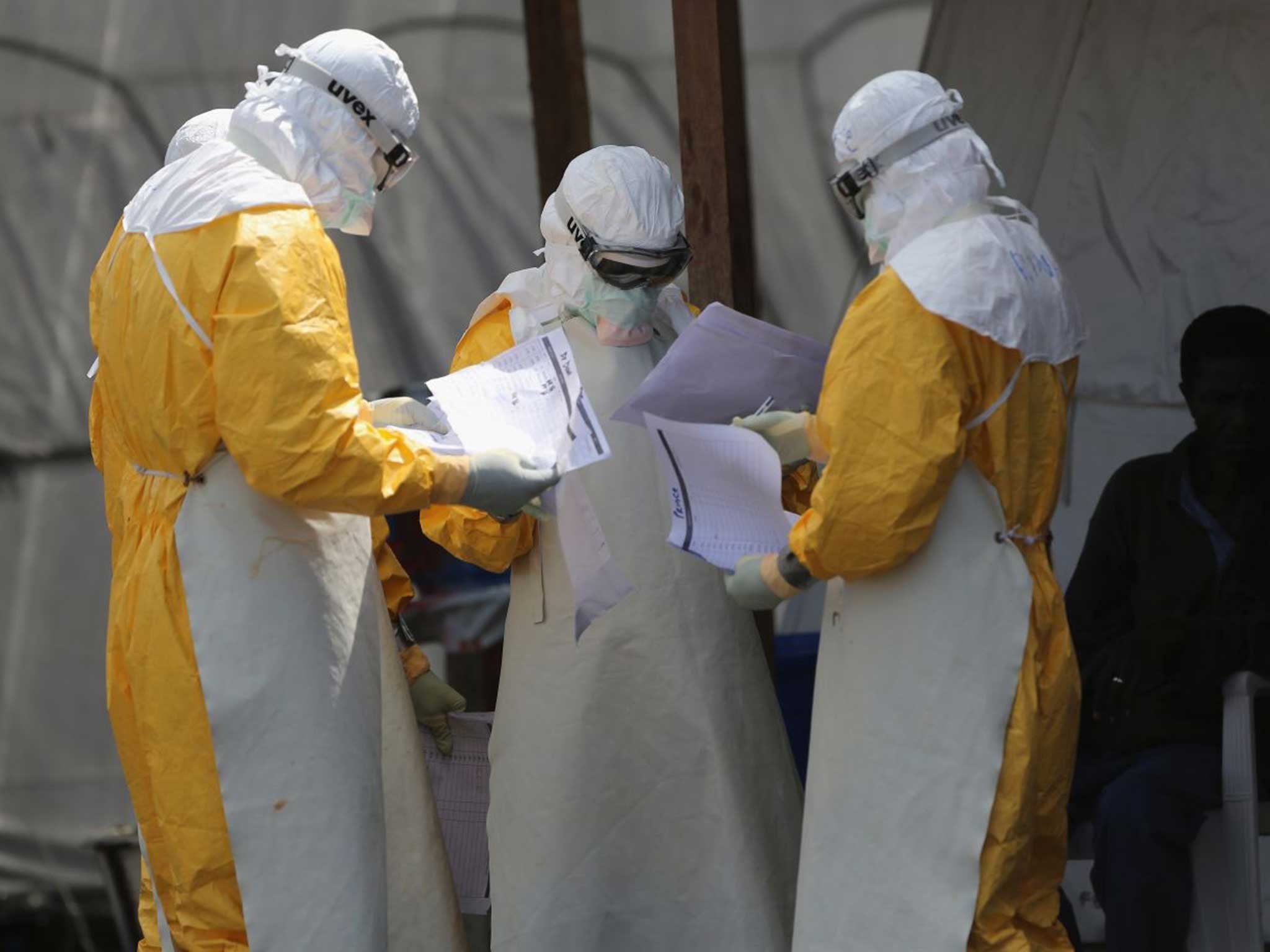 Health workers dressed in protective clothing in Liberia, one of six West African nations to be affected by Ebola.
