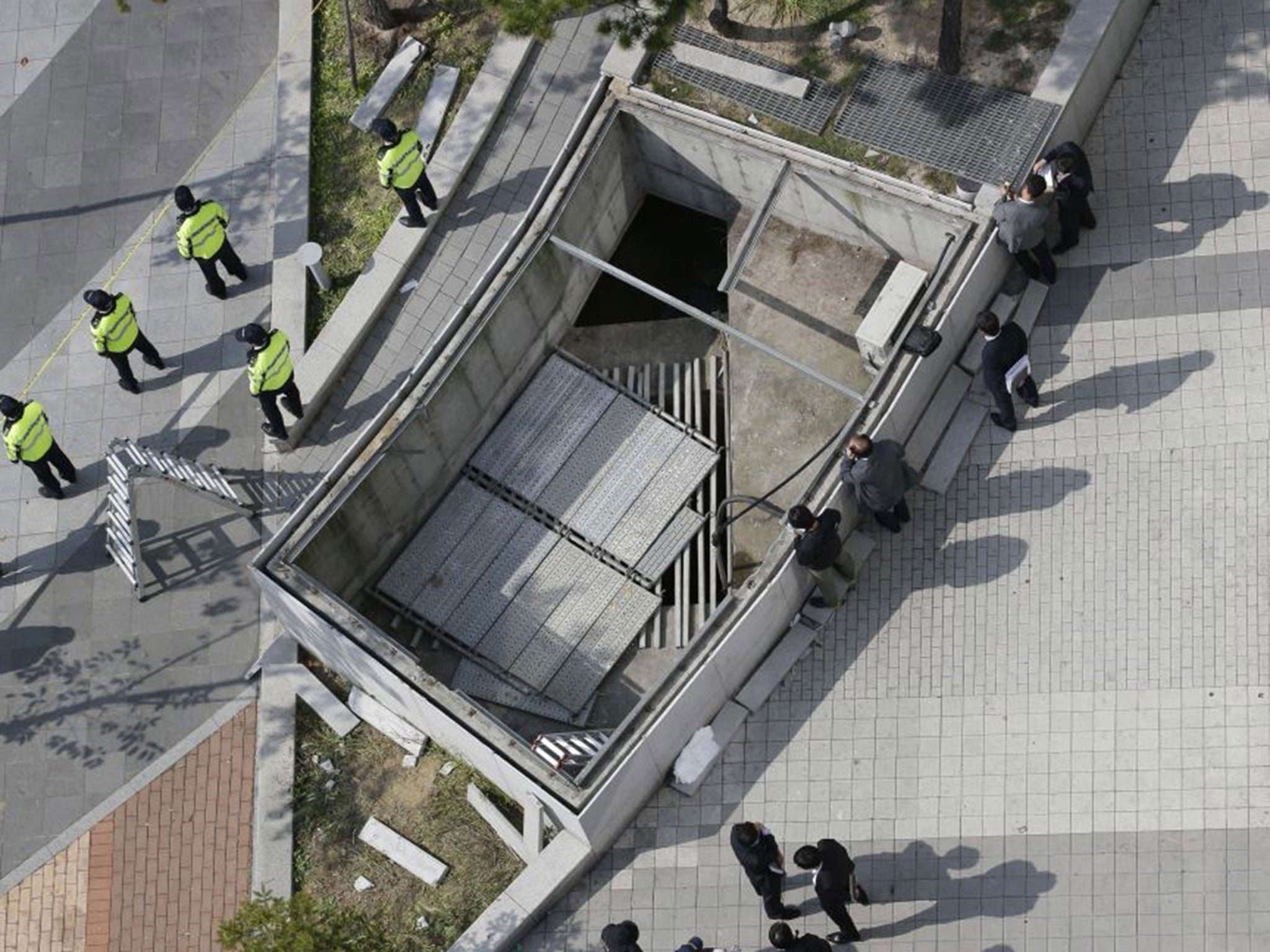 People standing on the grate when it collapsed during a pop concert in South Korea fell 20 meters (60 feet) to their deaths