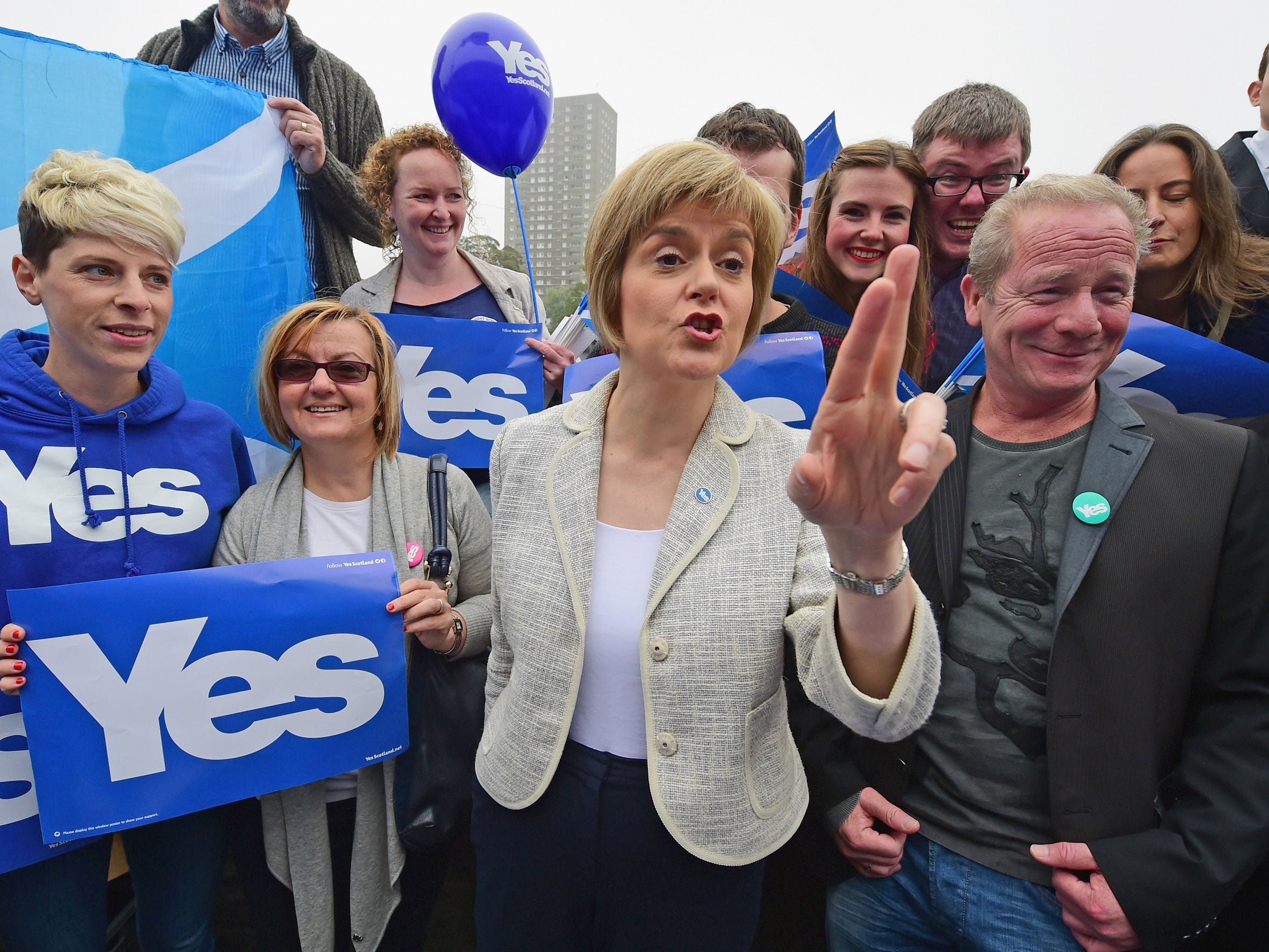 Deputy First Minister Nicola Sturgeon (L) and actor Peter Mullan campaign for the 'Yes' vote in Drumchapel on September 12,2014 in Glasgow, Scotland.
