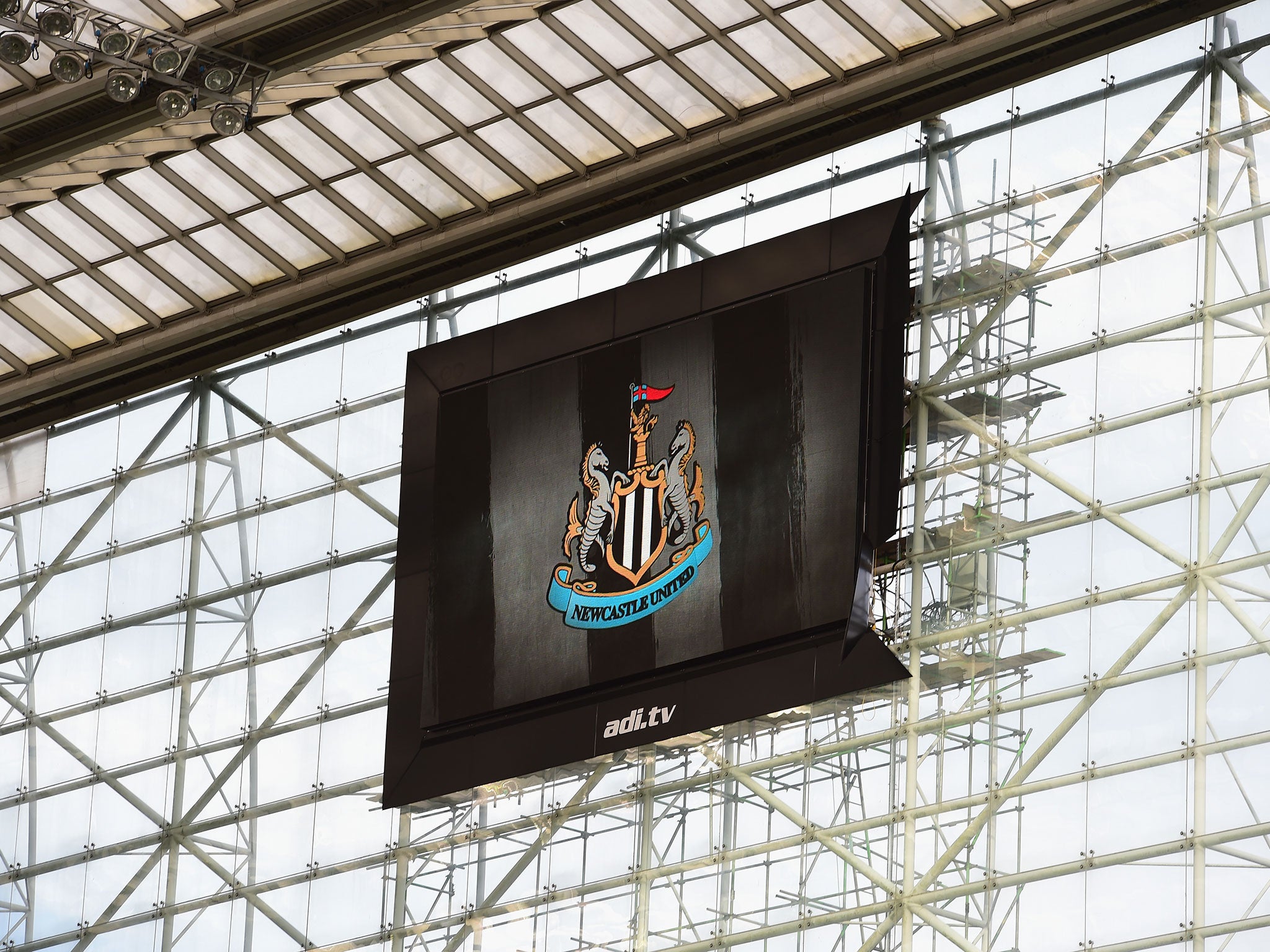 A big screen at Newcastle's St James' Park is blown lose by the wind