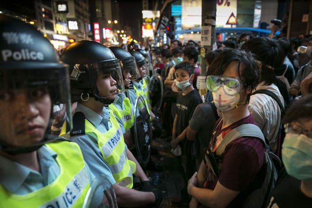 Hong Kong police confront protesters as they try to reclaim the core protest zone in Mong Kok on Friday night 
