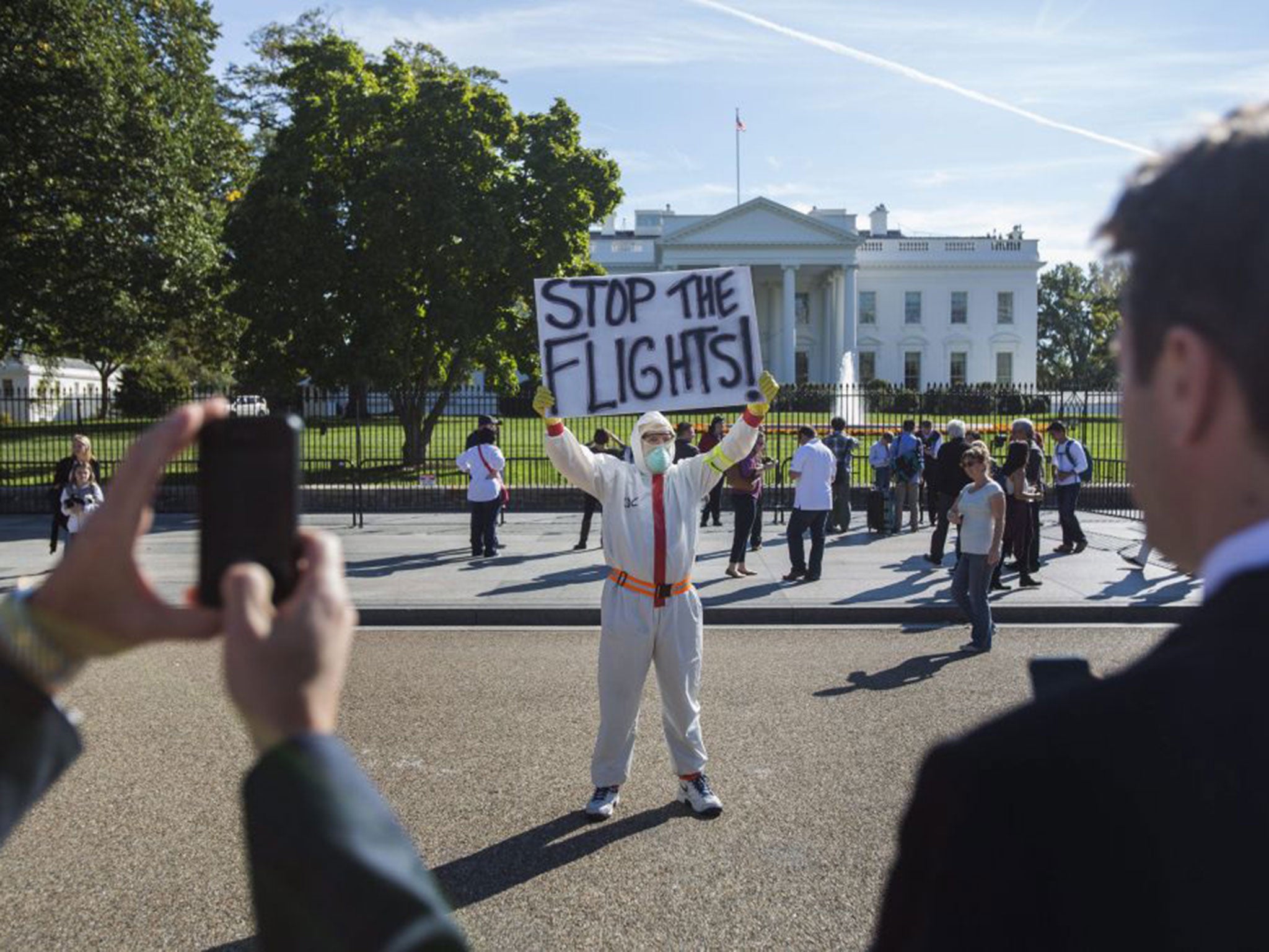 A protester outside the White House last Friday demands a travel ban from Africa