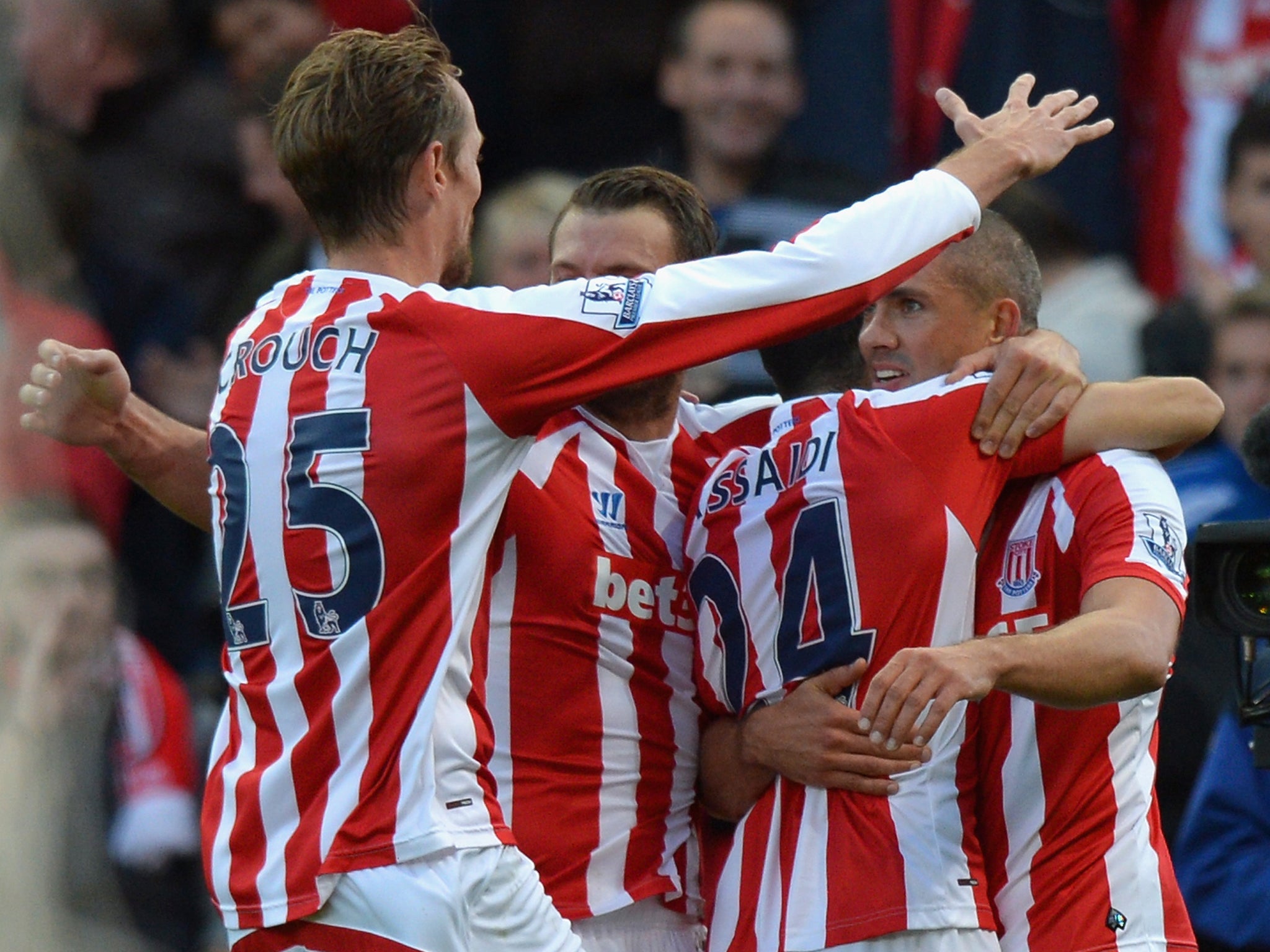 Jonathan Walters of Stoke City (R) is congratulated by team mates on scoring their second goal against Swansea