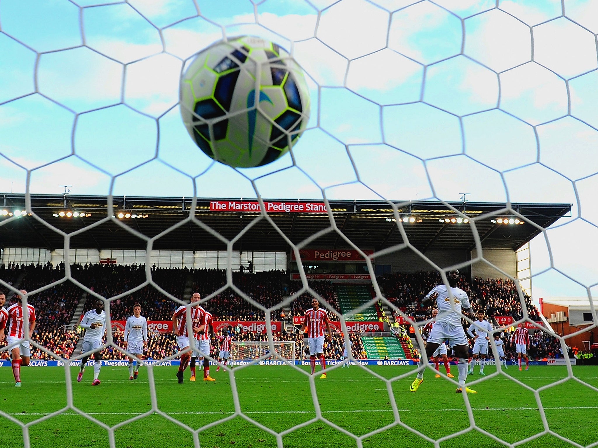 Wilfried Bony of Swansea City scores the first goal from the penalty spot