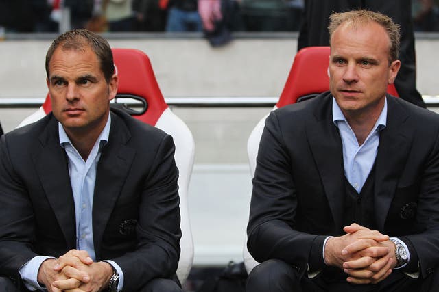 Dennis Bergkamp, right, has been linked with Championship outfit Reading