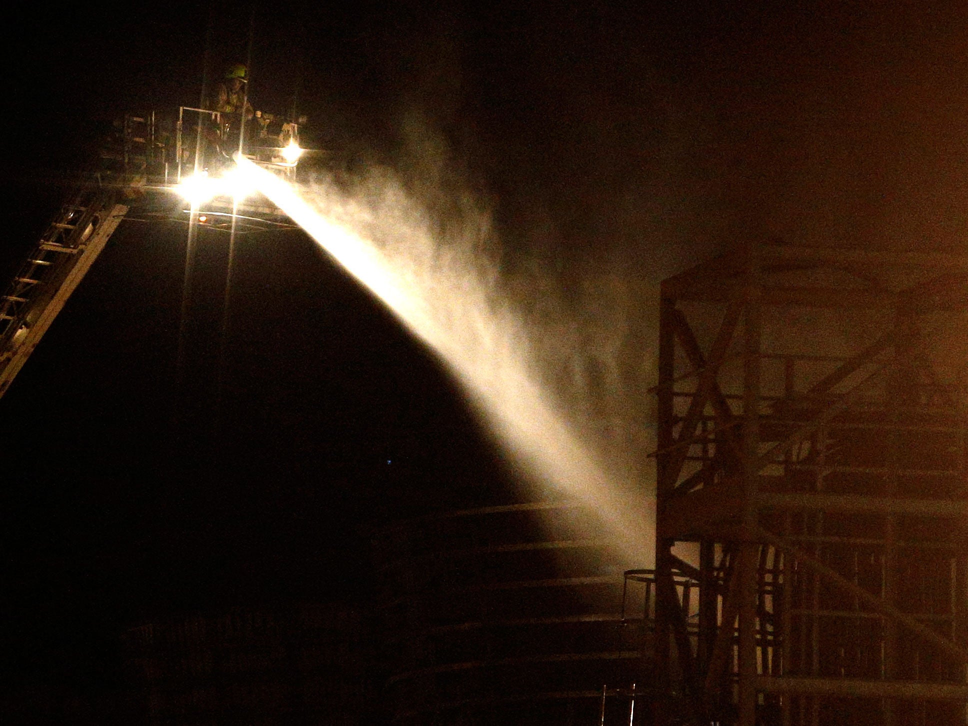 Fire crews spray water at the scene of the fire