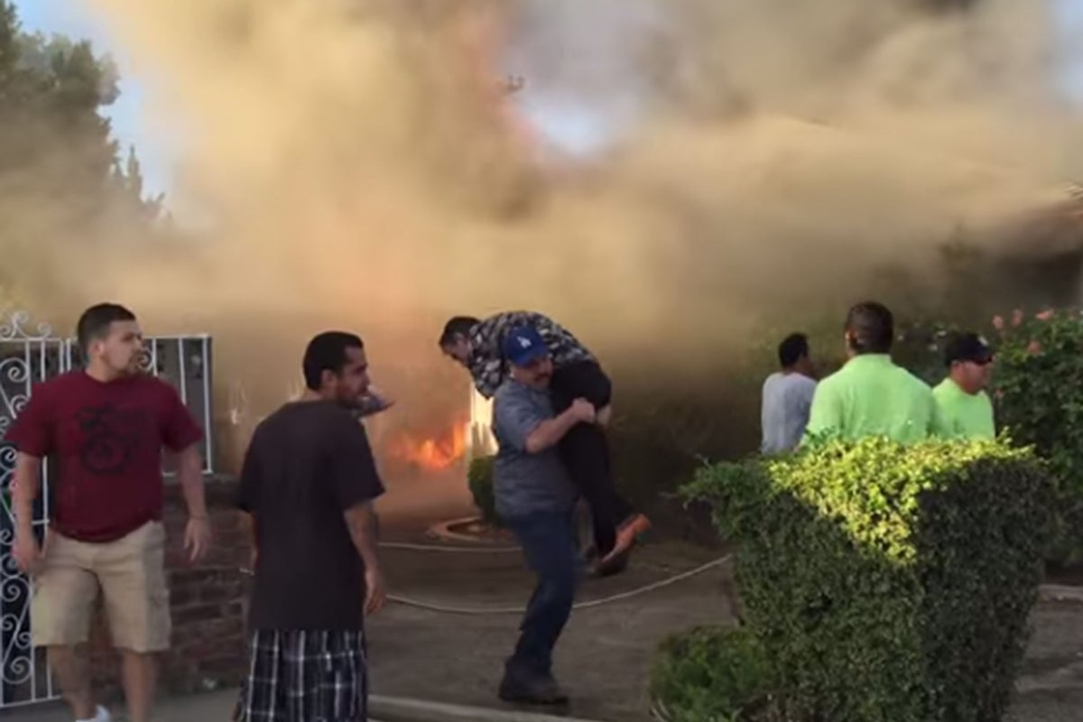 Video: Stranger carries man to safety as his home goes up in flames ...