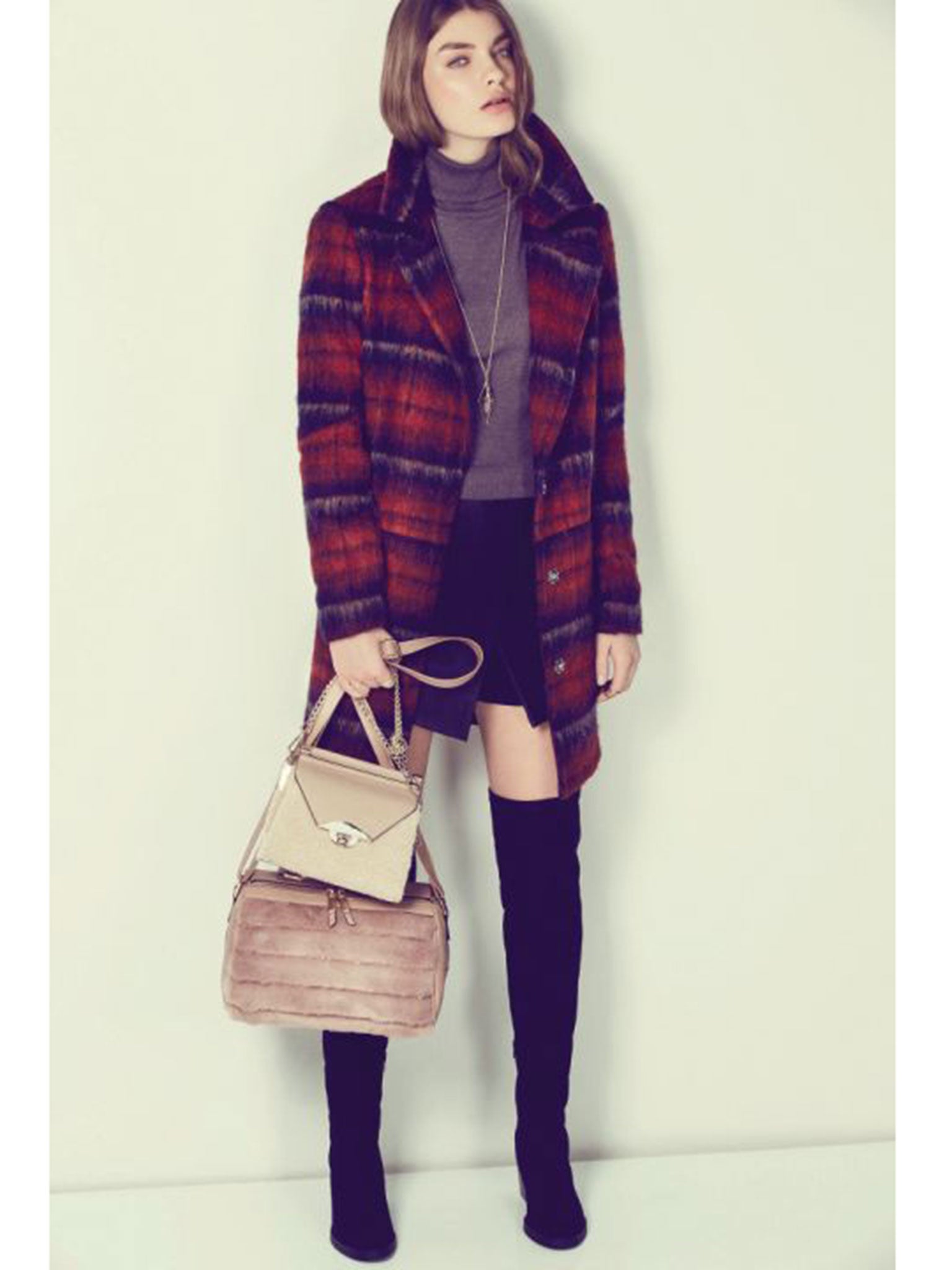 Model wears coat £54.99; skirt £19.99; jumper £19.99; pink bag £19.99; cream bag £29.99; boots £49.99; all newlook.com