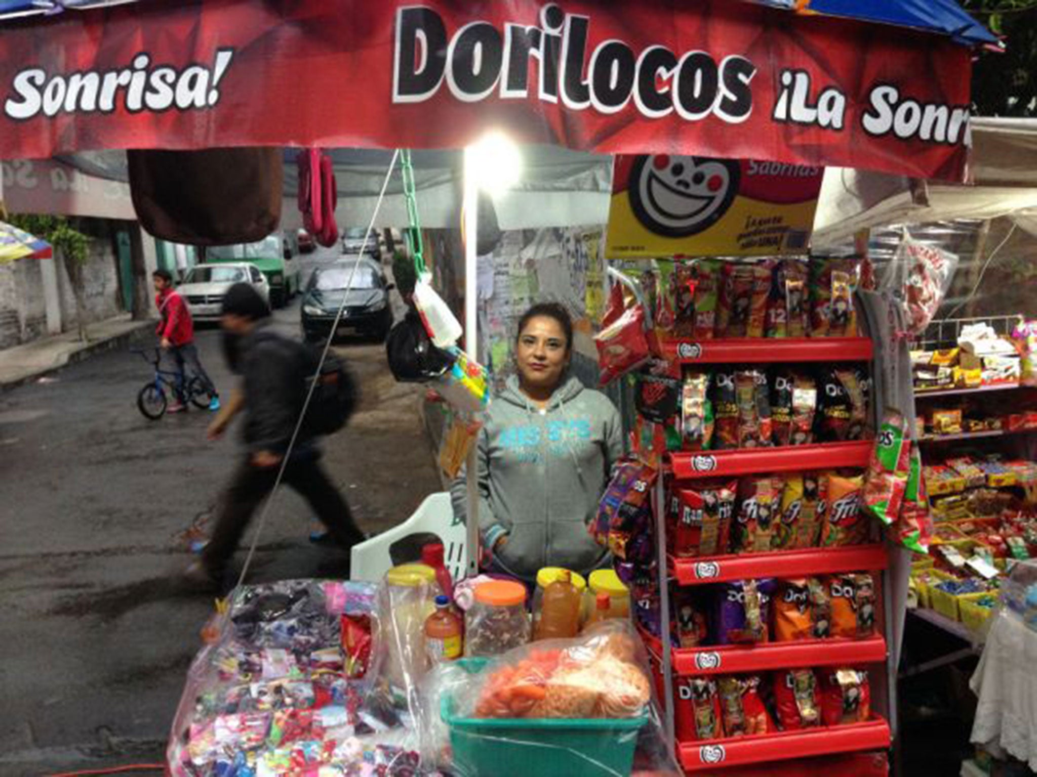 A street vendor in Mexico City sells Dorilocos, which are topped with carrot, jimaca, cucumber, peanuts, pork rinds, spices and hot sauce (The Washington Post)