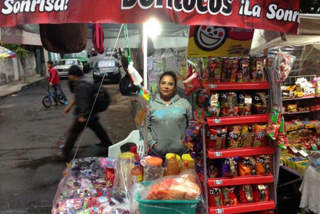 A street vendor in Mexico City sells Dorilocos, which are topped with carrot, jimaca, cucumber, peanuts, pork rinds, spices and hot sauce (The Washington Post)