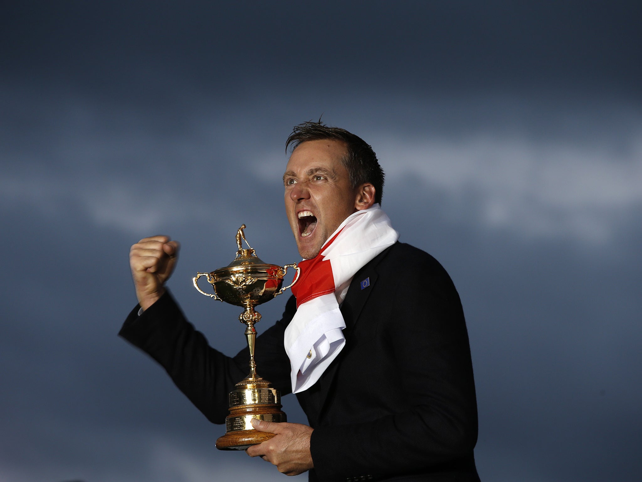 Ian Poulter of England poses with the trophy after Team Europe retained the Ryder Cup on the final day of the Ryder Cup