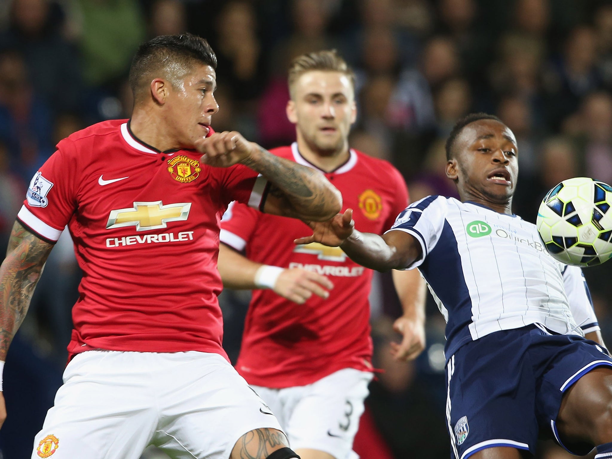 Marcos Rojo competes for the ball with Berahino