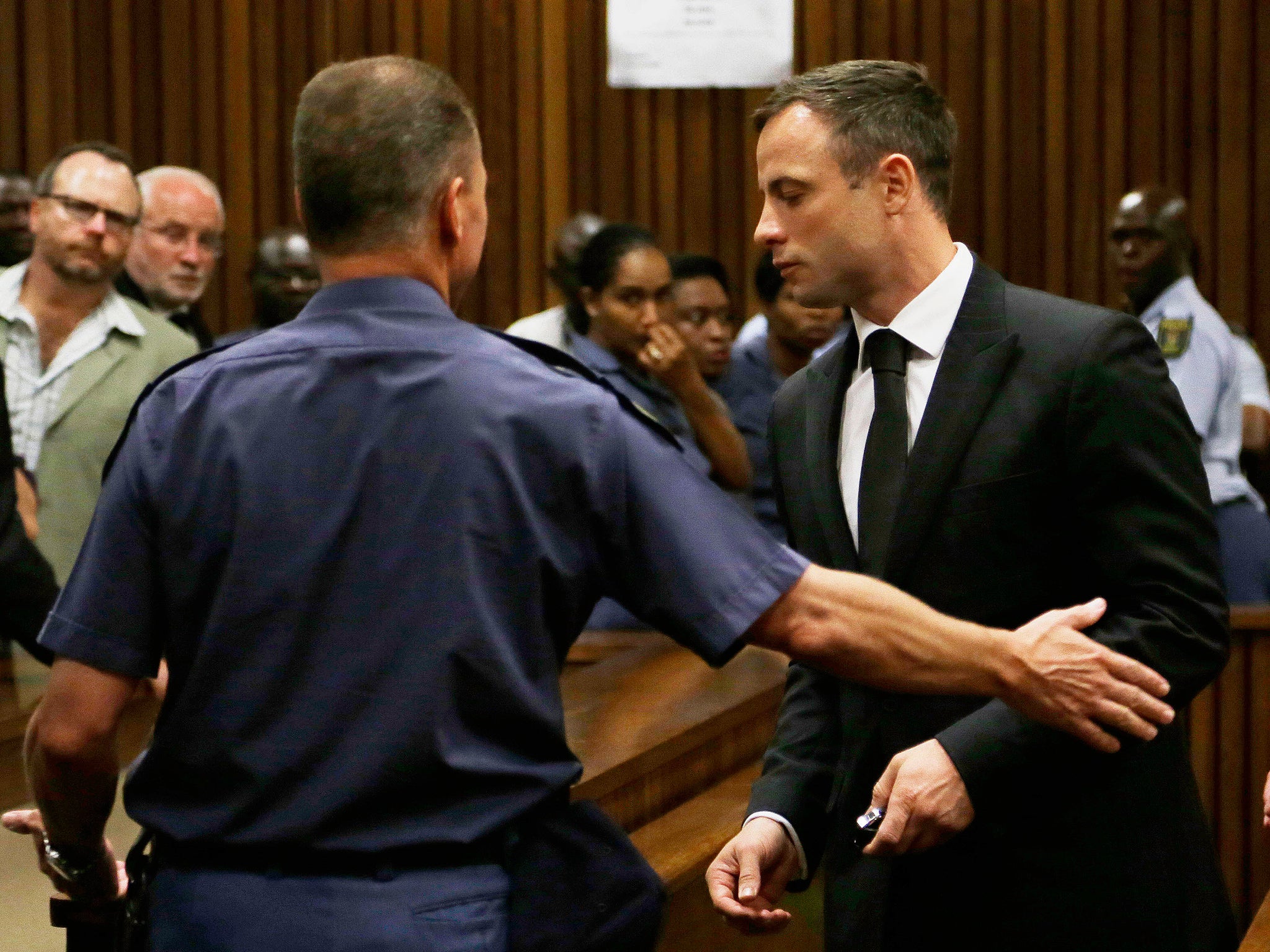 Oscar Pistorius is led out of court in Pretoria. Pistorius received a five-year prison sentence for culpable homicide by judge Thokozile Masipais for the killing of his girlfriend Reeva Steenkamp