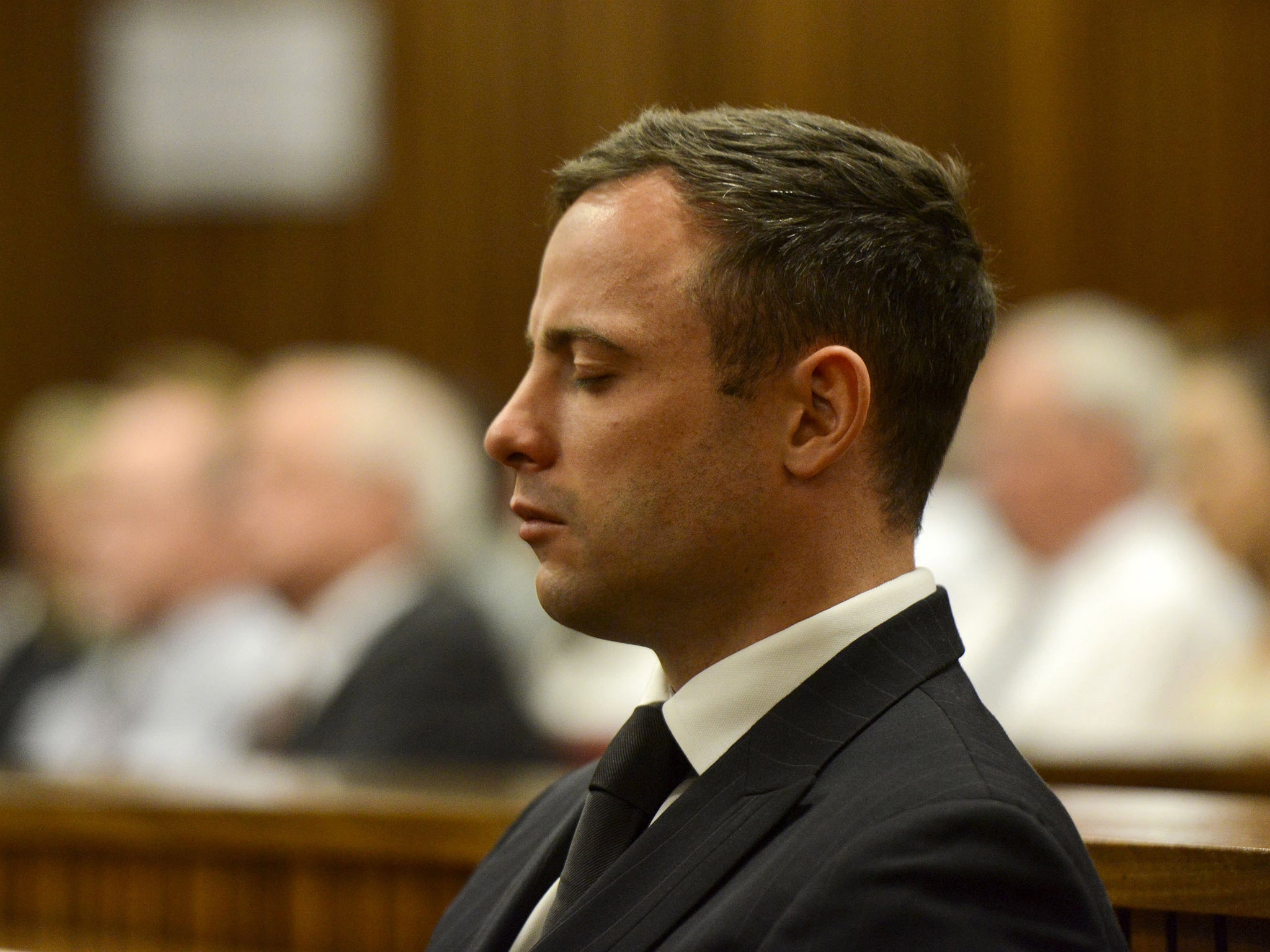 Oscar Pistorius listens to his judgement in the Pretoria High Court