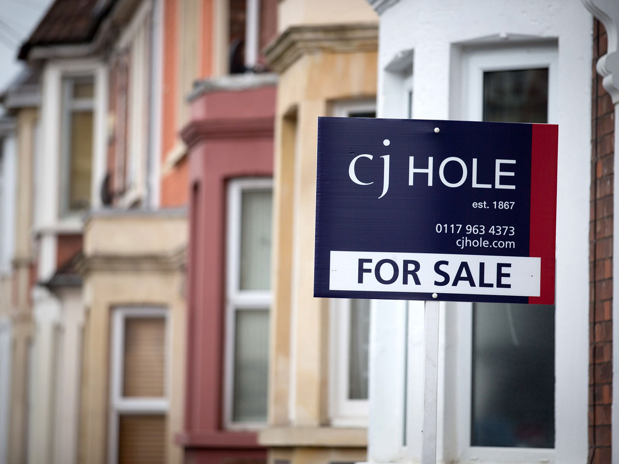 An estate agent's board is seen outside a property on October 8, 2014 in Bristol, England.