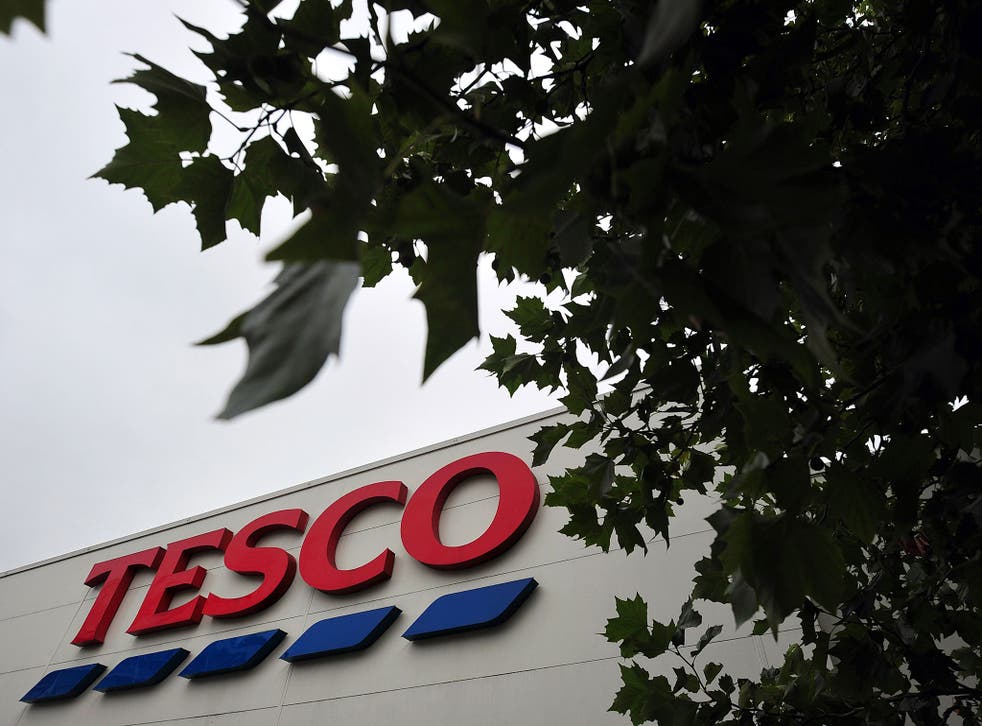 A Tesco logo is pictured outside a supermarket in south London, on October 2, 2013.