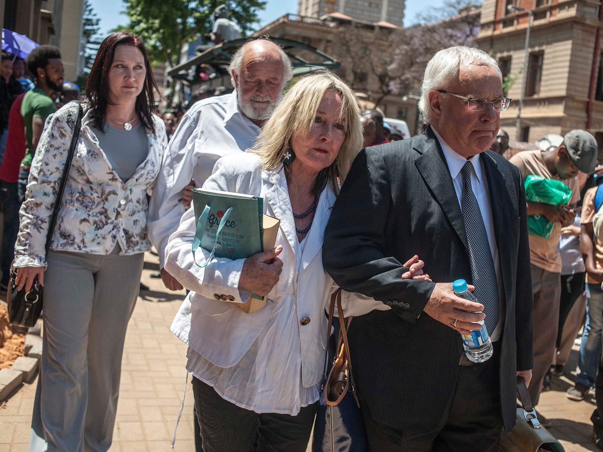 Parents of Reeva Steenkamp leave the High Court in Pretoria after Oscar Pistorius was sentenced to 5 years in prison