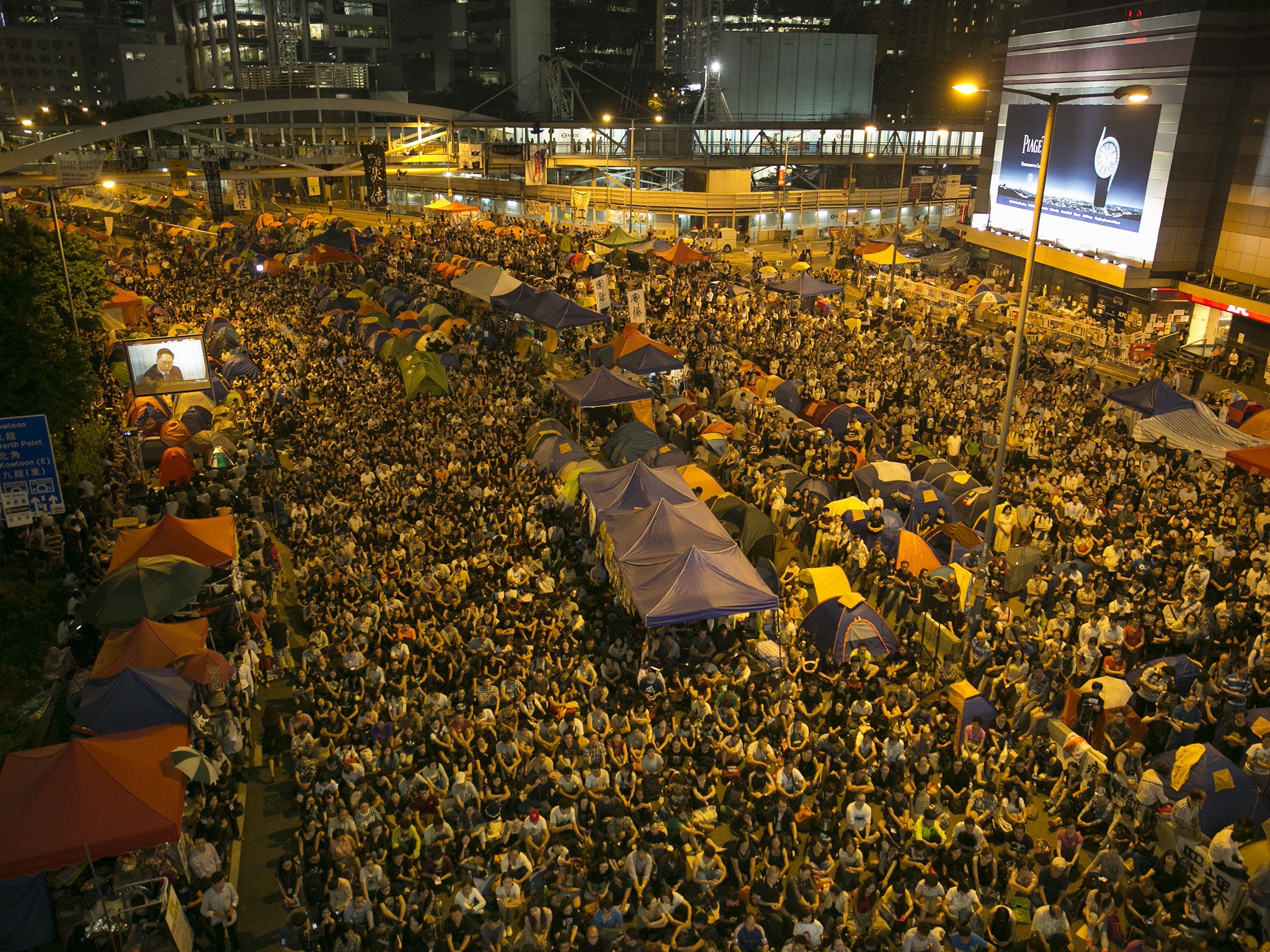 Tens of thousands of protesters gather to listen to the talks between the government officials and the protesters tonight at the main protest site on October 21, 2014 in Hong Kong.