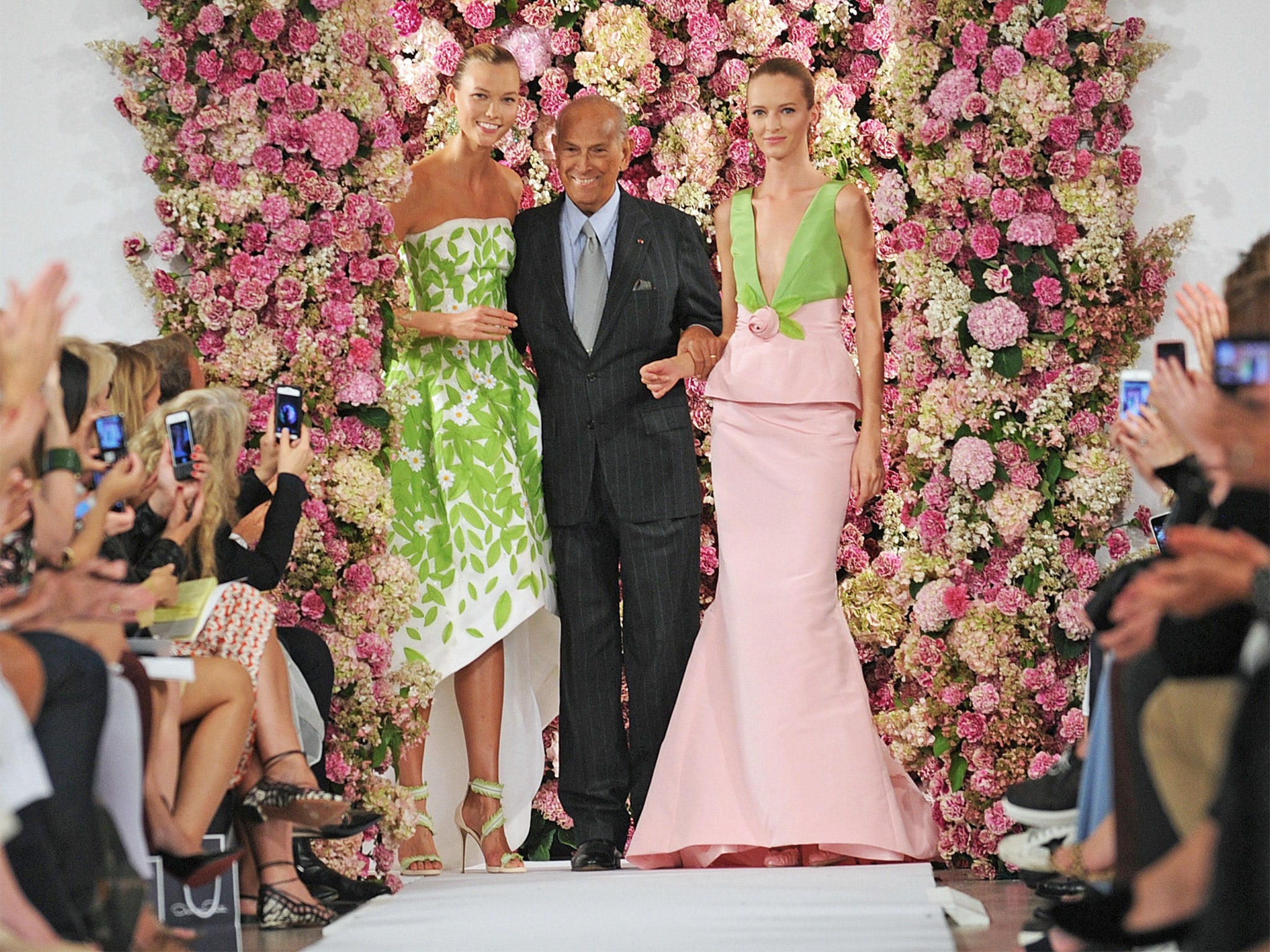 Designer Oscar de la Renta takes a bow after showing his Spring 2015 collection in September, his last show before his death