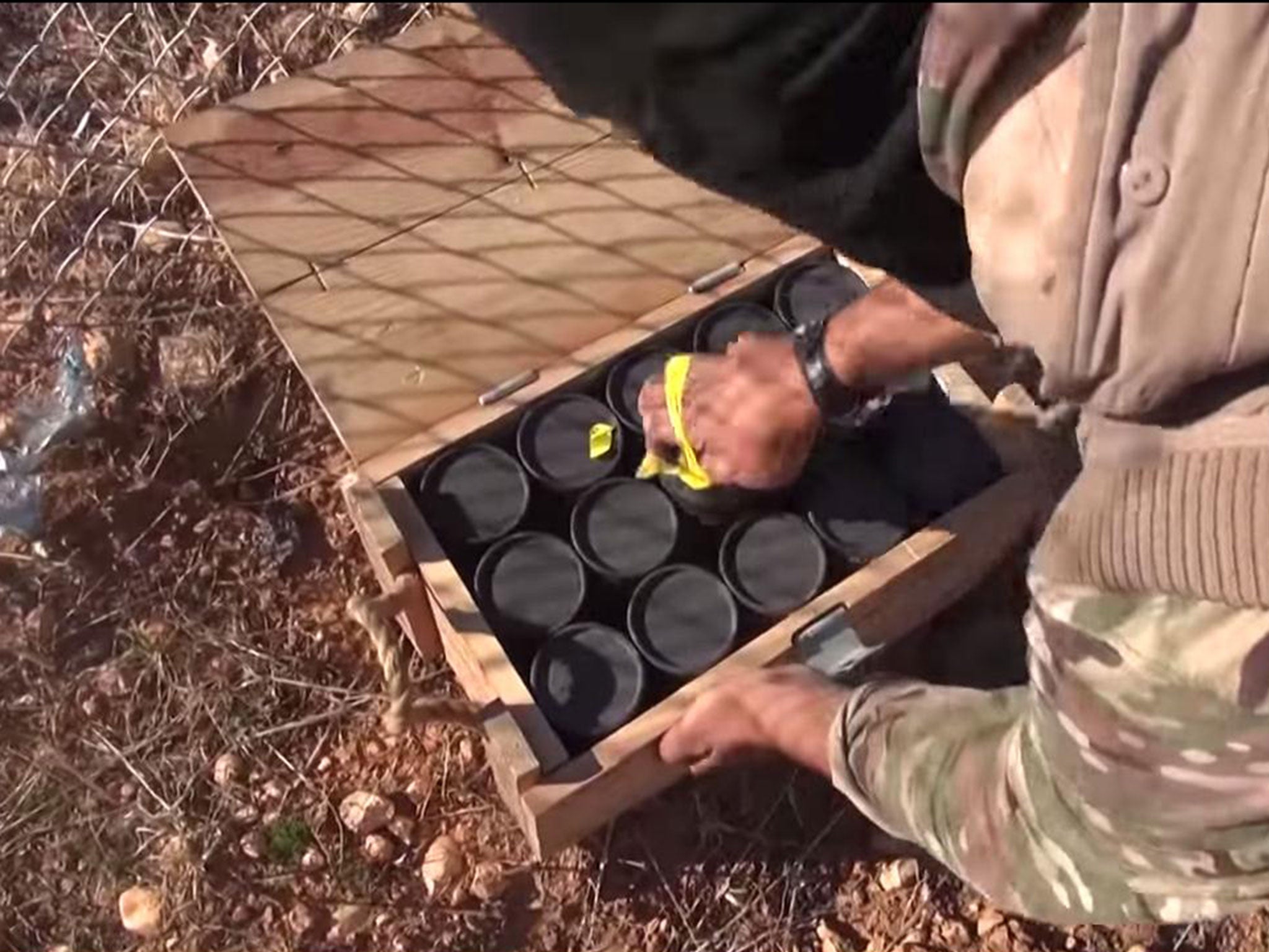 Isis fighters going through boxes they claim were dropped by the US