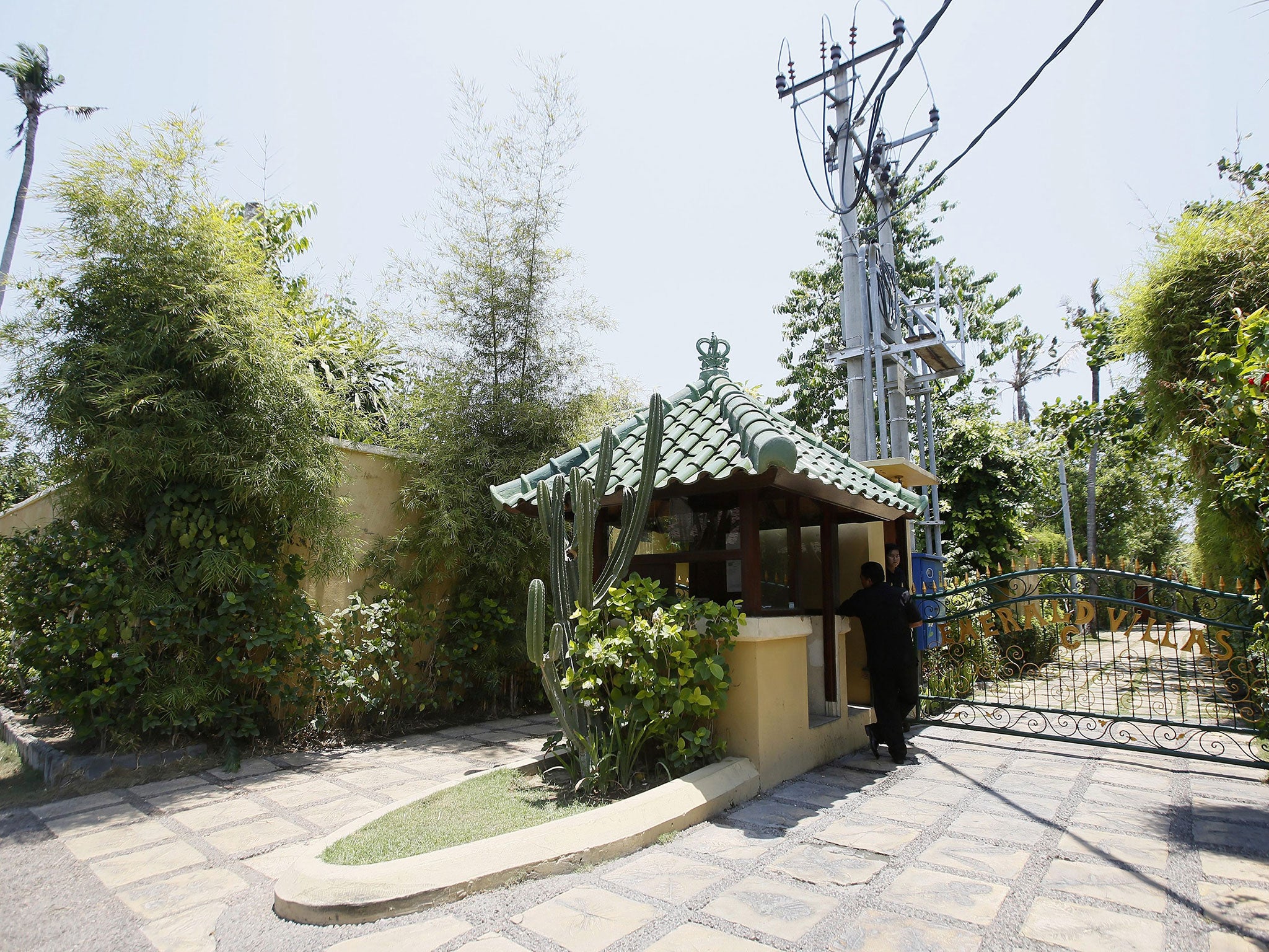 A security guard stands at the entrance of Emerald Villa complex, where British man Robert Kelvin Ellis lived, in Sanur, Bali, Indonesia,