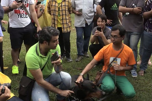Organiser Syed Azmi (right) meets a dog