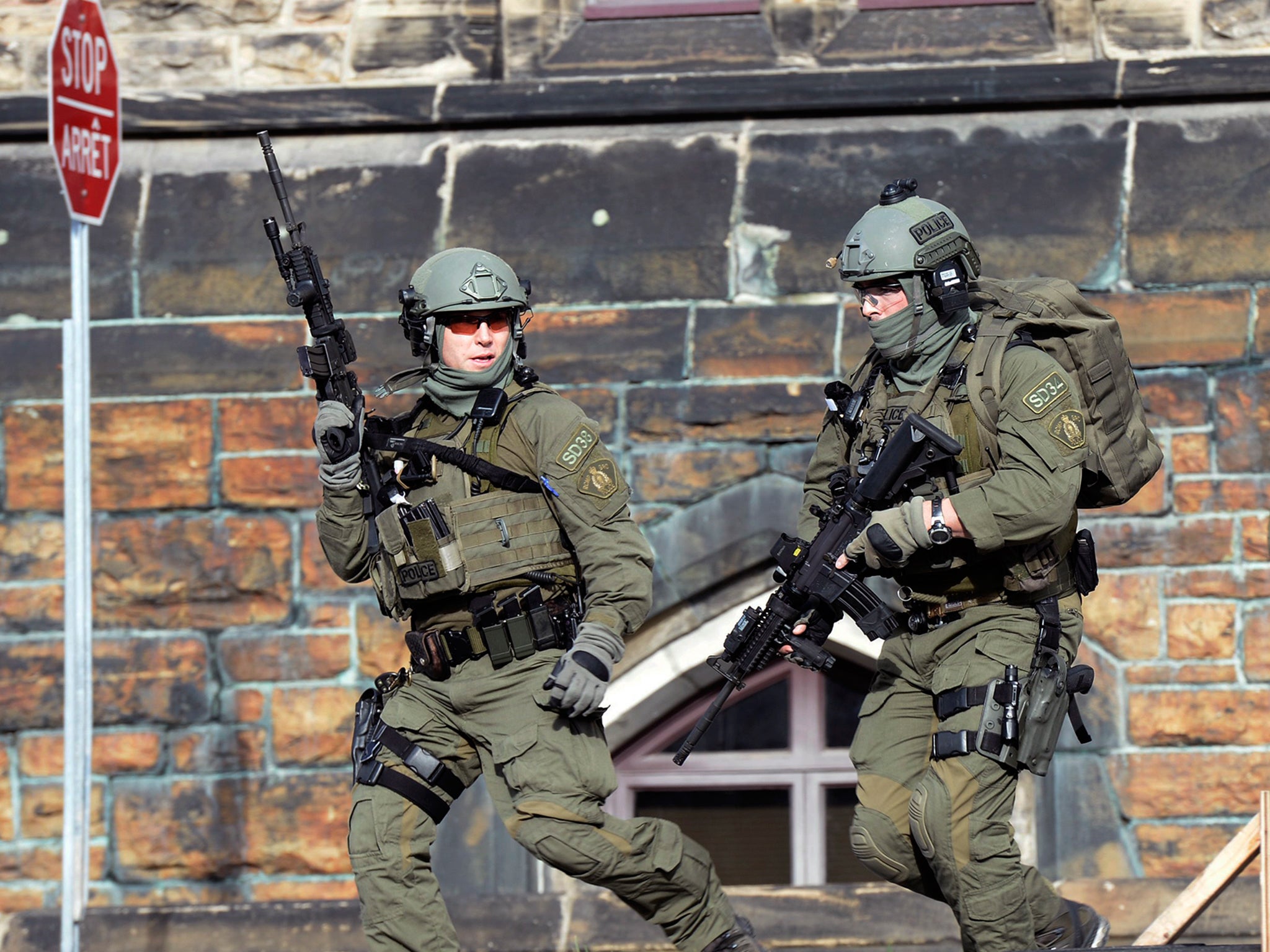 A Royal Canadian Mounted Police intervention team responds to a reported shooting at Parliament building in Ottawa