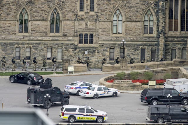 Armed police teams enter Centre Block at Parliament Hill in Ottawa