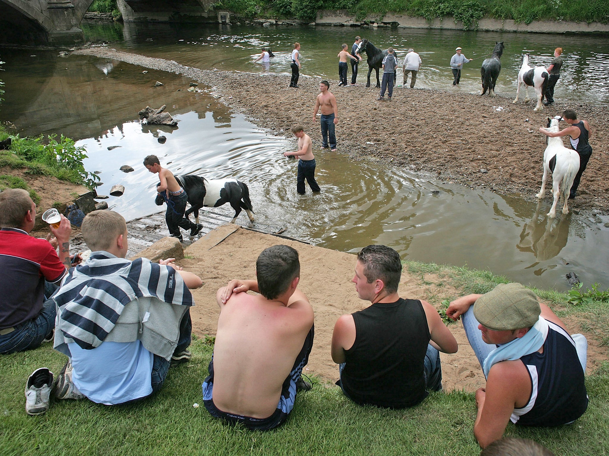 Gypsies wash their horses in the River Eden at the Appleby Horse Fair