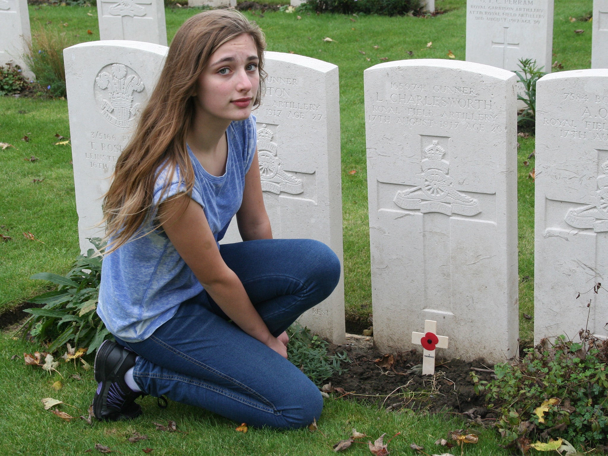 Sophie Crane, of Avon Valley School in Rugby, at the grave of her great grandmother’s cousin in Vlamertinghe New Memorial Cemetery, Belgium