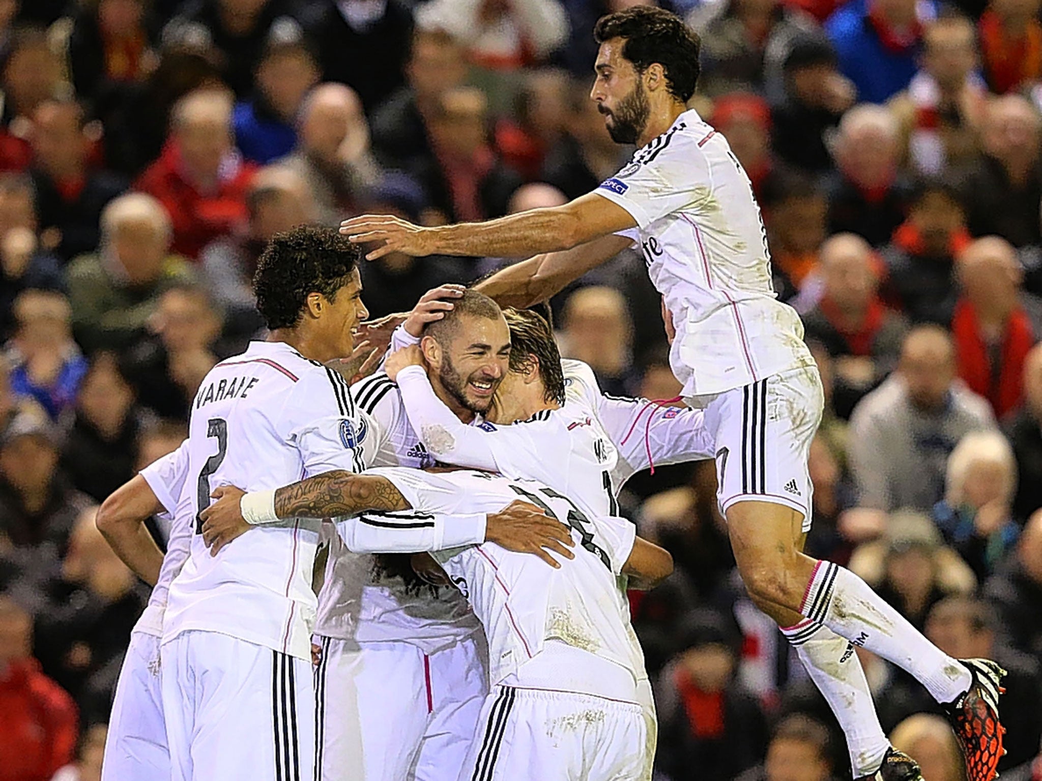 Karim Benzema (centre) is mobbed after scoring Real’s third goal