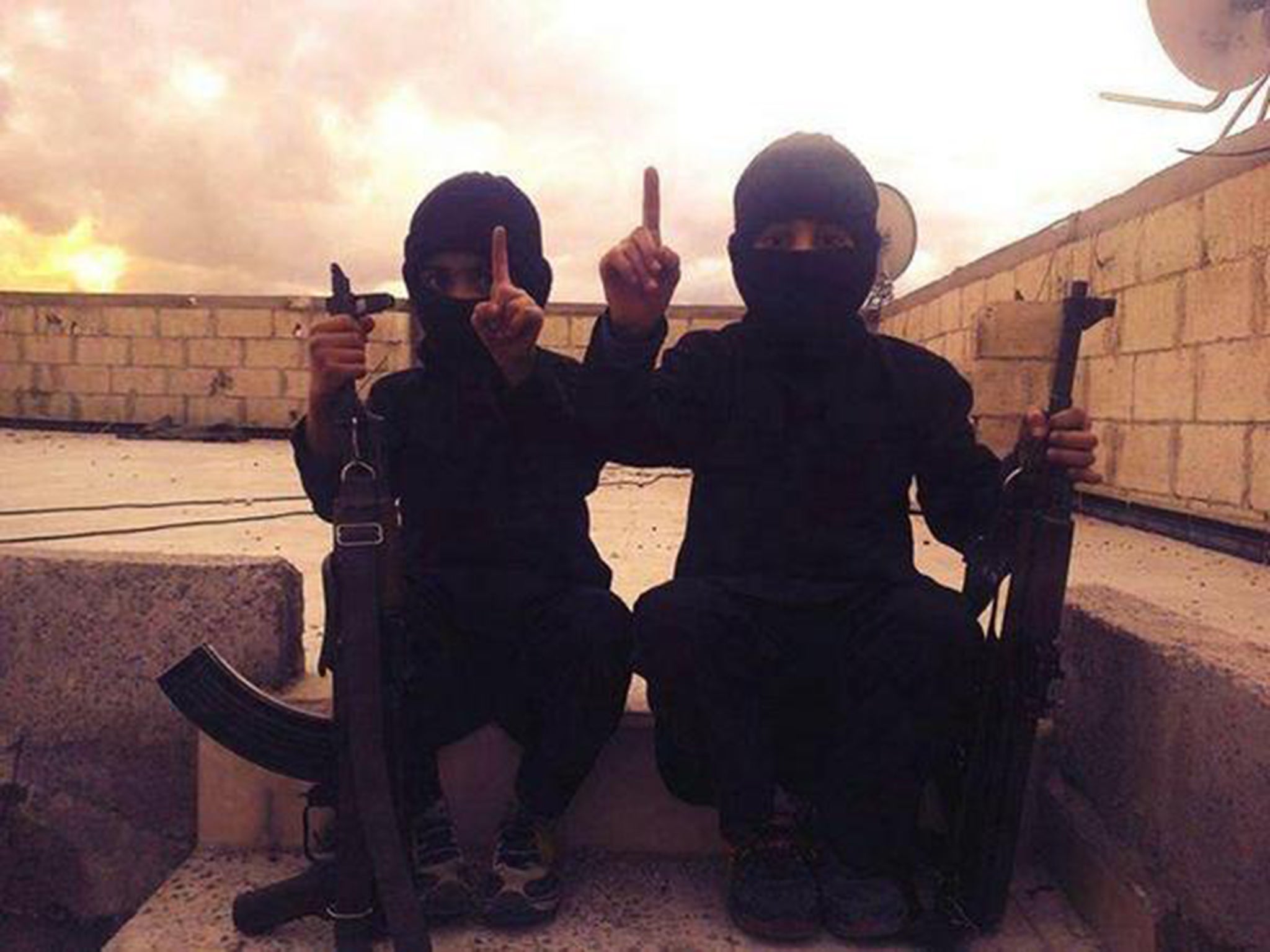 An image posted on 21 October by an Isis-linked Twitter feed, with a caption in Arabic calling these children 'new graduates of Jihad School'