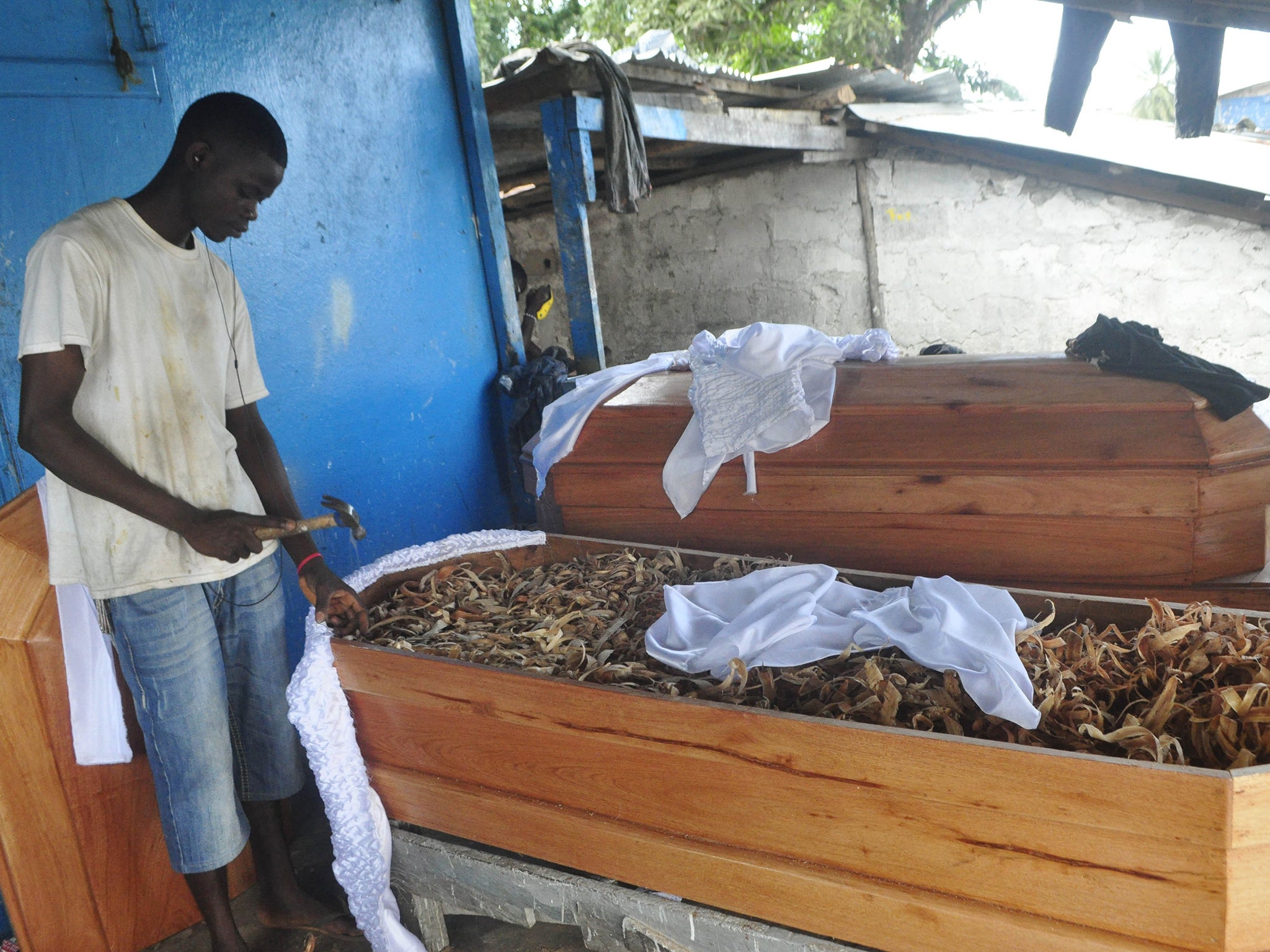 A carpenter makes coffins in New Kru in Monrovia, Liberia