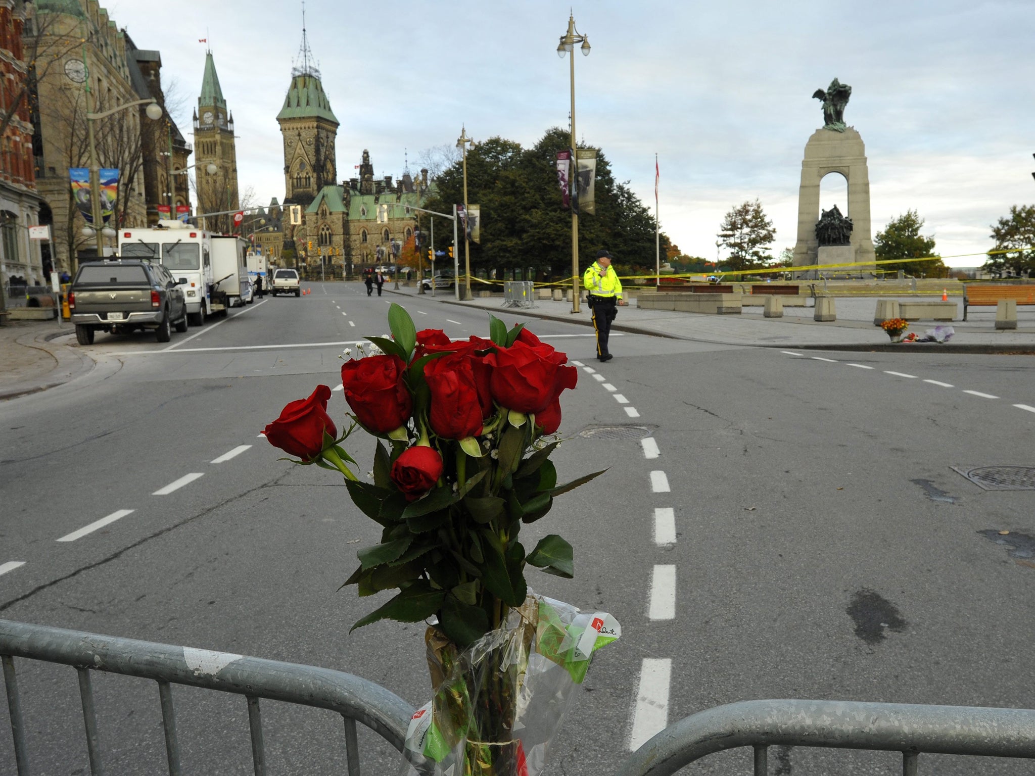 Flowers adorn a barricade around the National War Memorial in Ottawa, Canada